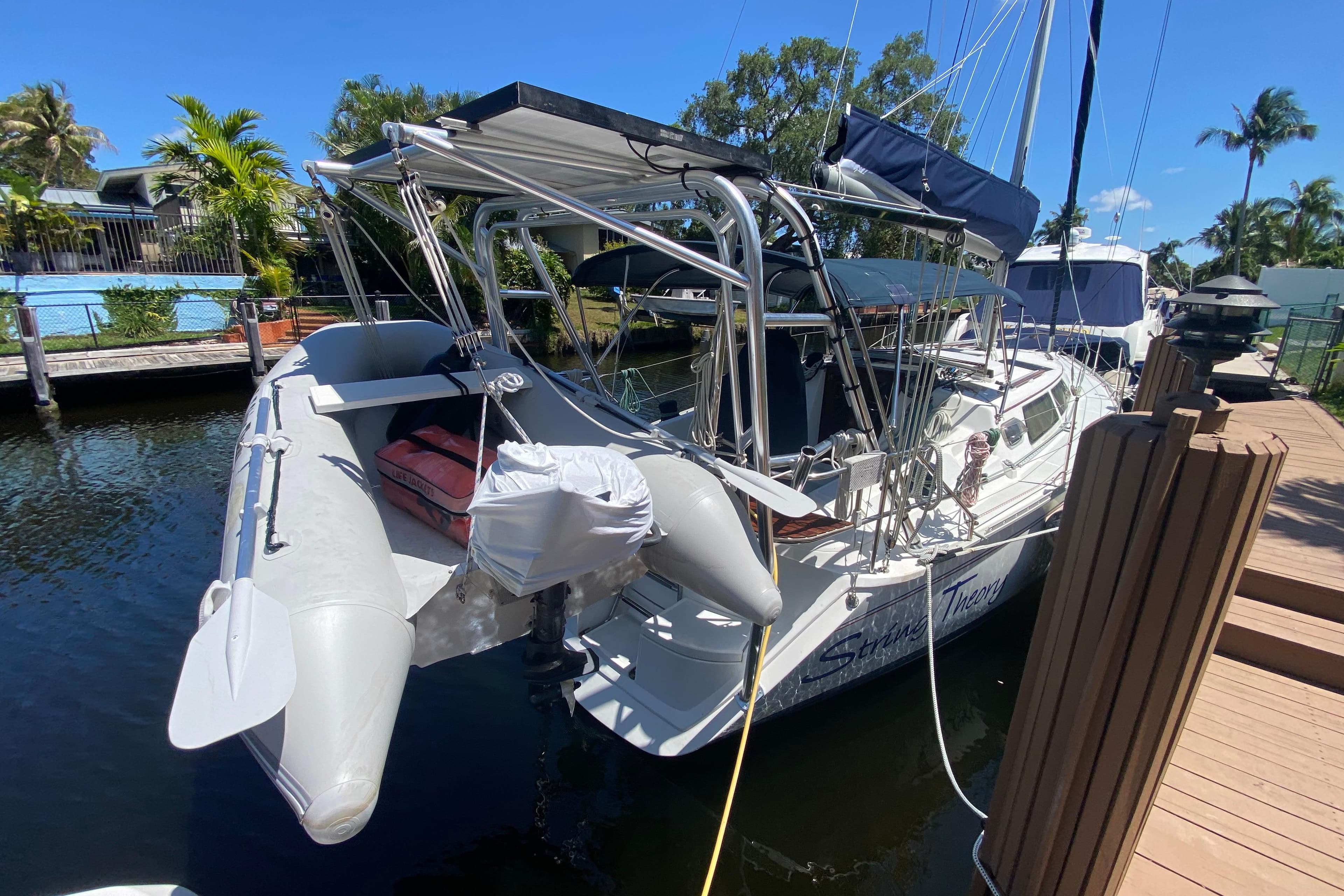 Hunter 33.5 sailboat from 1995 docked with inflatable dinghy attached.