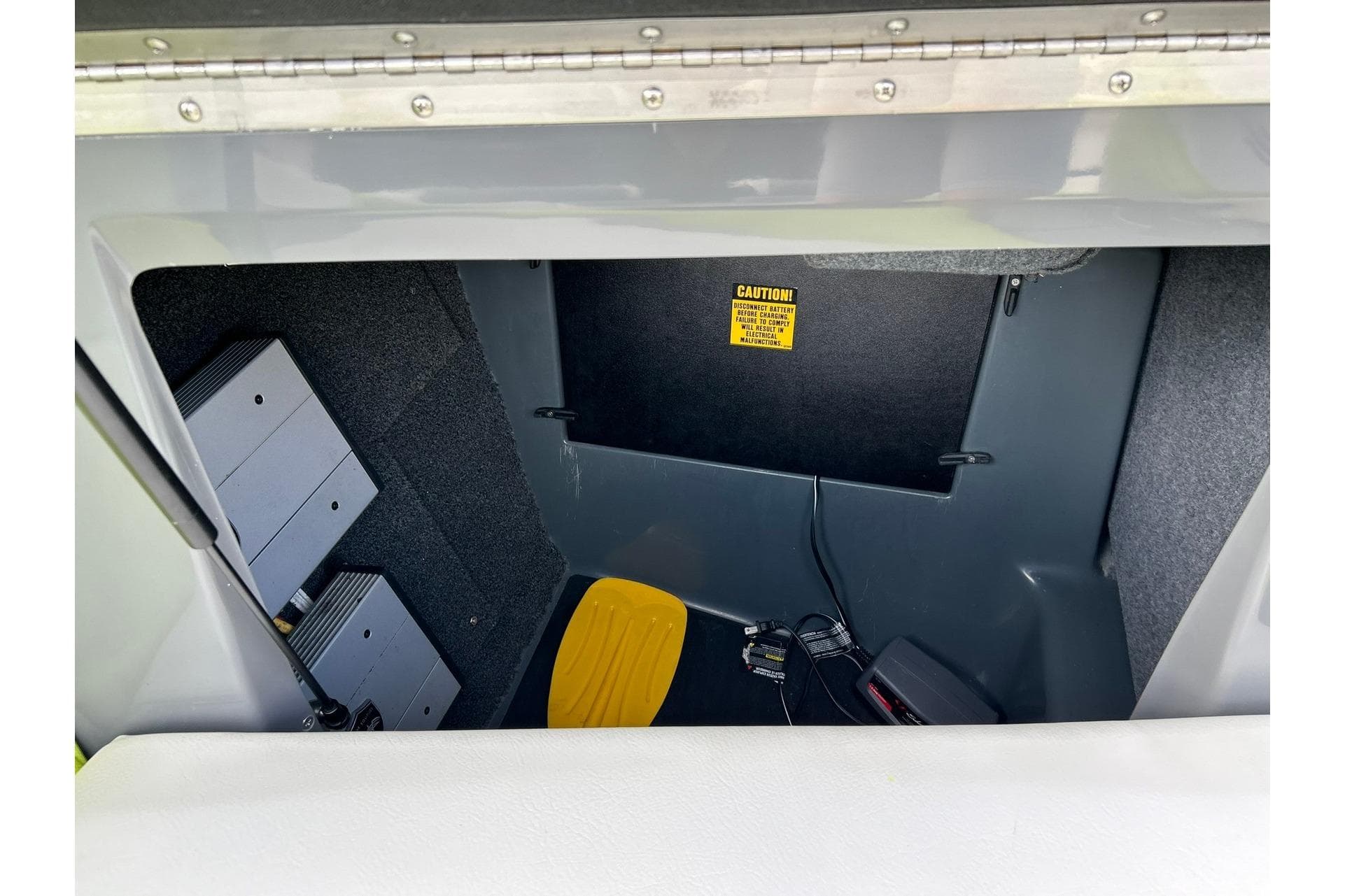 2021 ATX 22 Type-S storage compartment with electronic components and caution label.