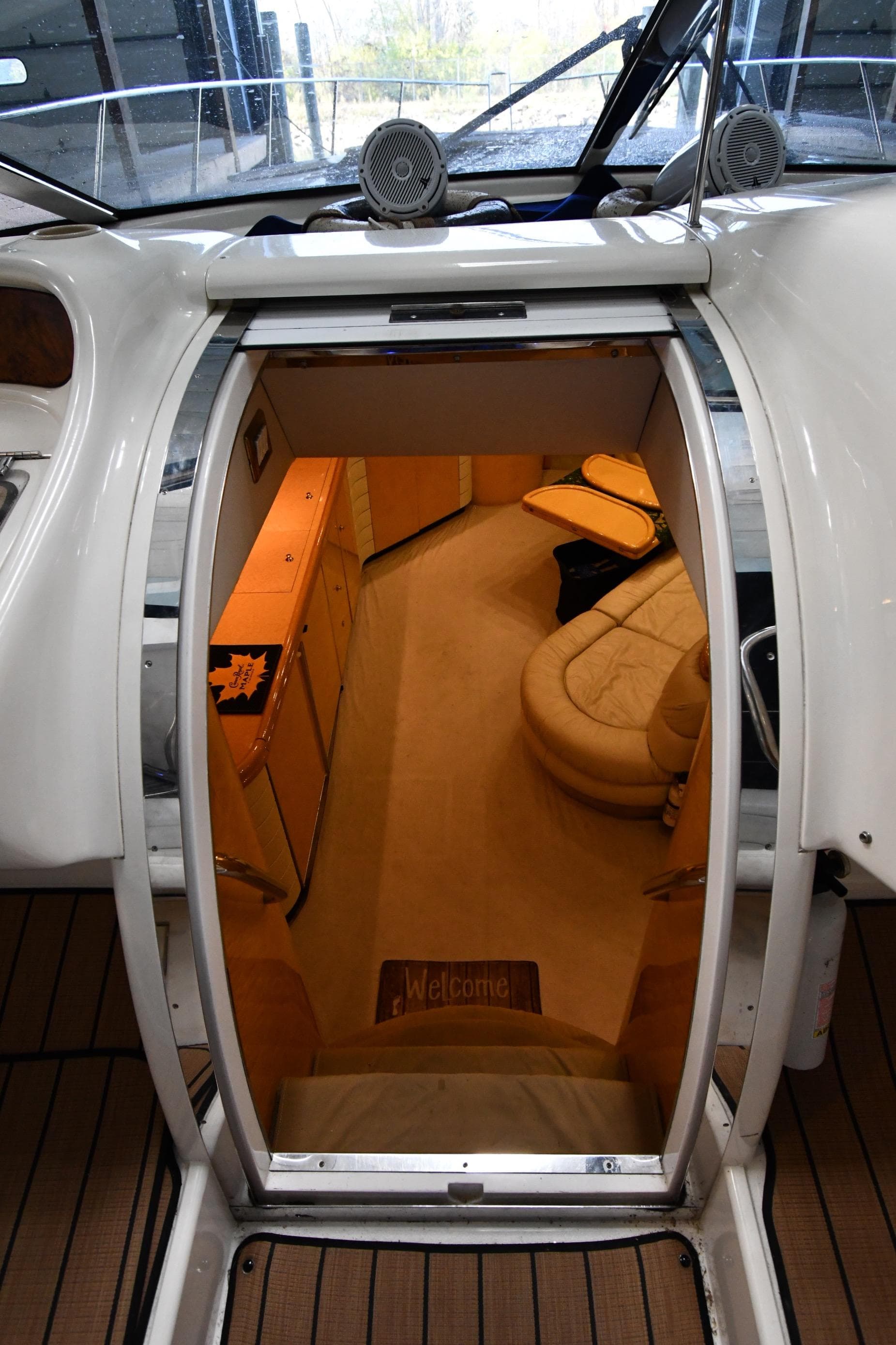 Interior view of 1996 Sunseeker 55 CAMARGUE yacht, featuring luxurious seating and wooden cabinetry.