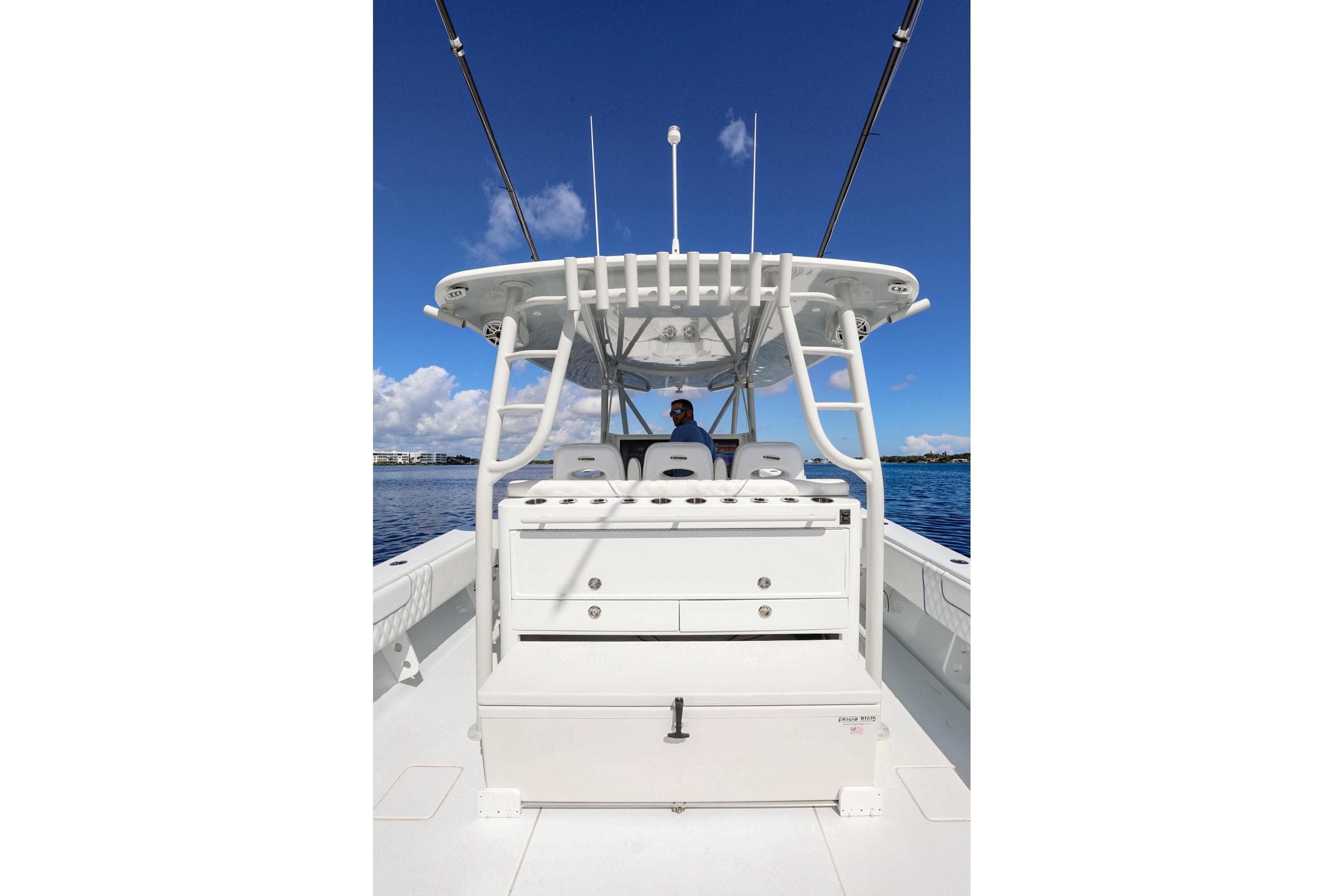 2023 Contender 44 ST boat with center console, white seating, and blue sky background.