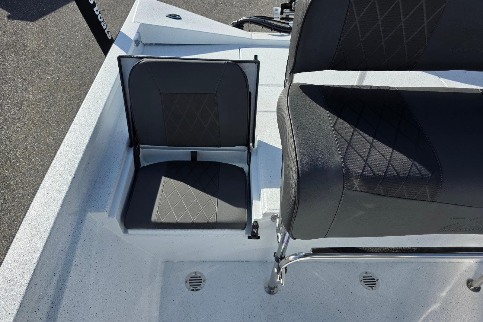 2026 Xpress H20B Bay boat seating with diamond-stitched upholstery, showcasing modern design.