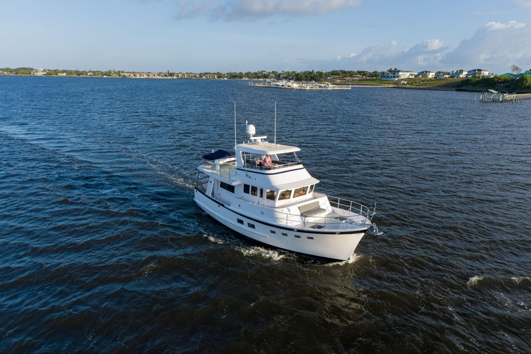 2027 Krogen 50 Open yacht cruising on a sunny day in open waters.