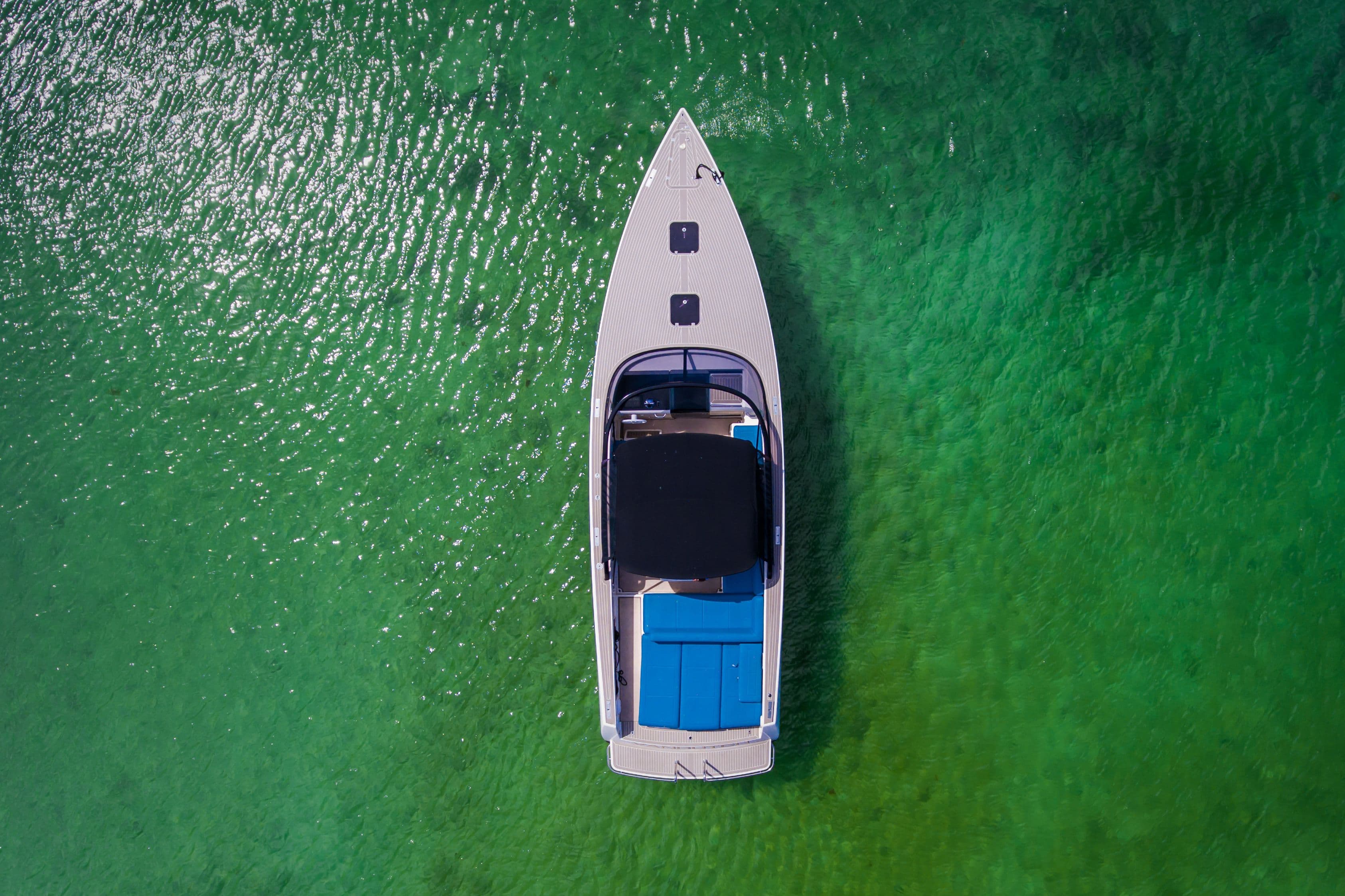 Aerial view of a 2014 VanDutch 40 yacht on green water.