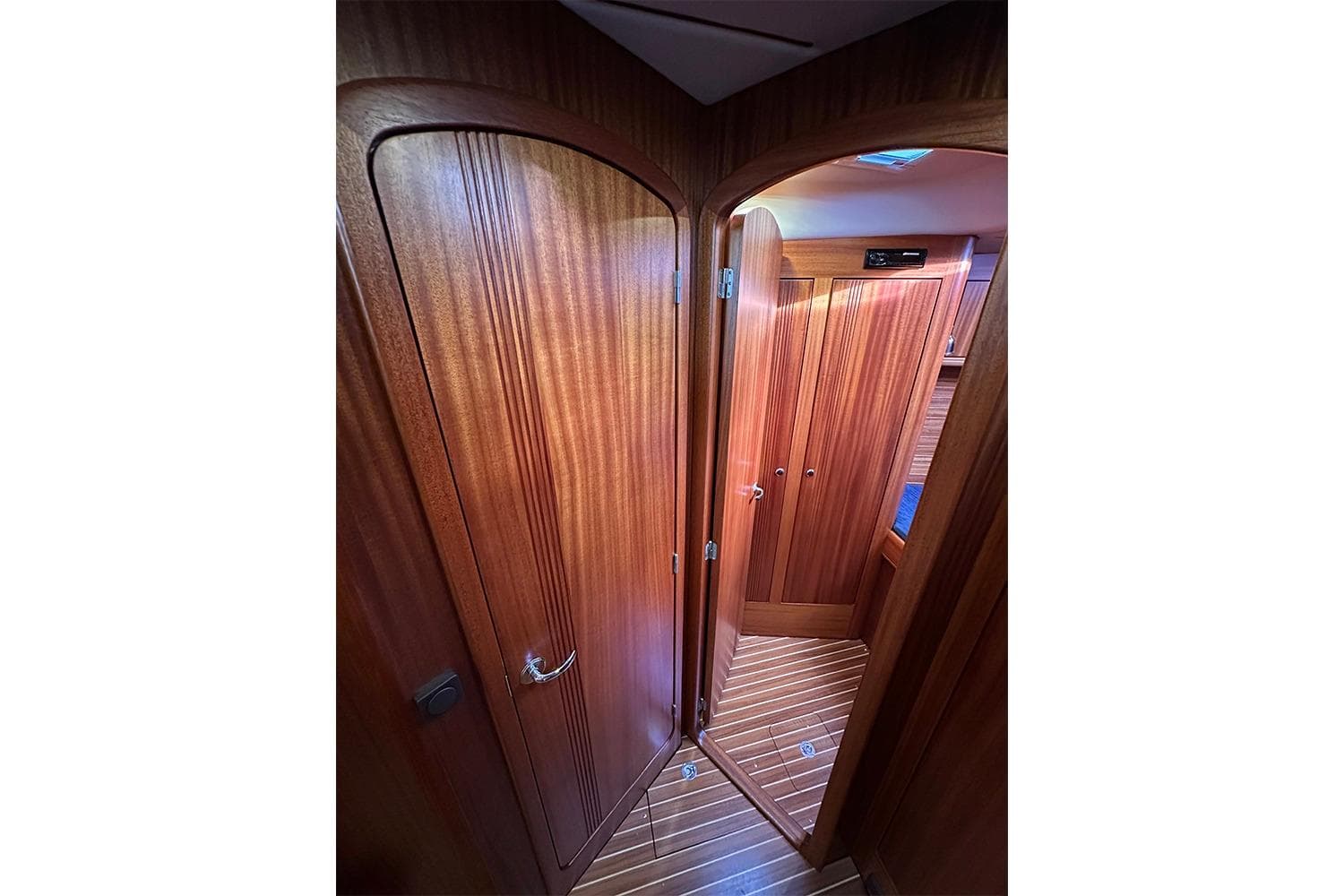 Wooden interior of 2004 Najad 460 yacht, featuring elegant doors and flooring.