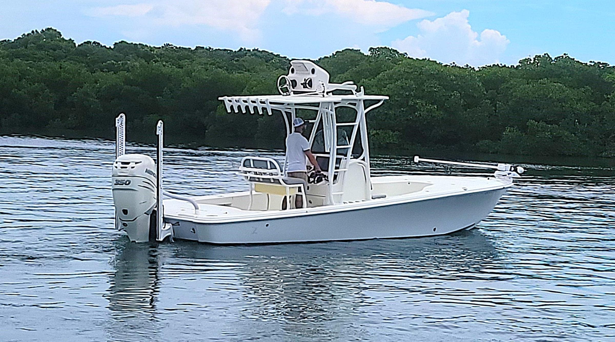 2017 SeaVee 270Z boat on calm water, surrounded by lush greenery.
