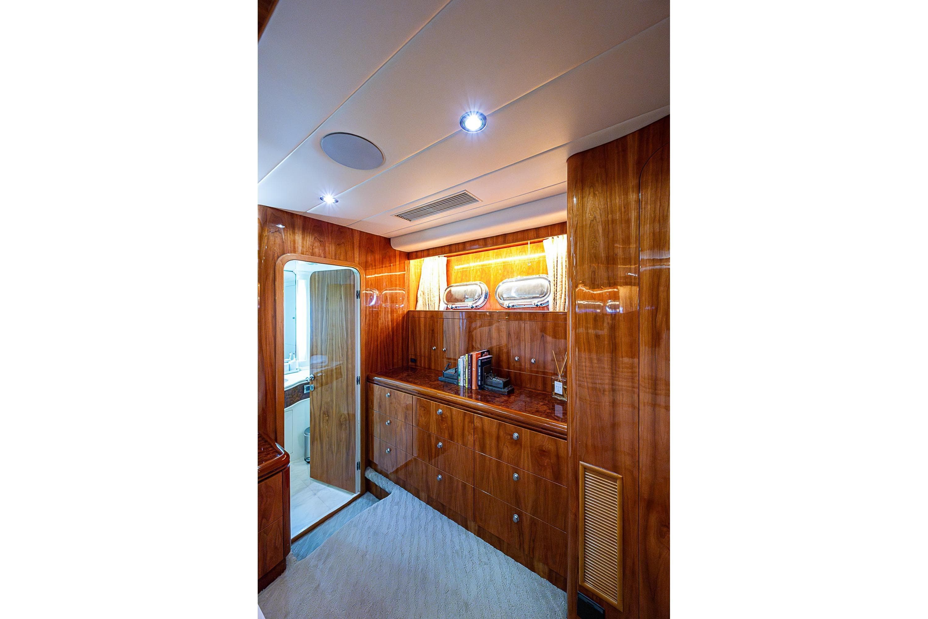 Luxurious wooden interior of 2000 Horizon 82 yacht with elegant cabinetry and lighting.