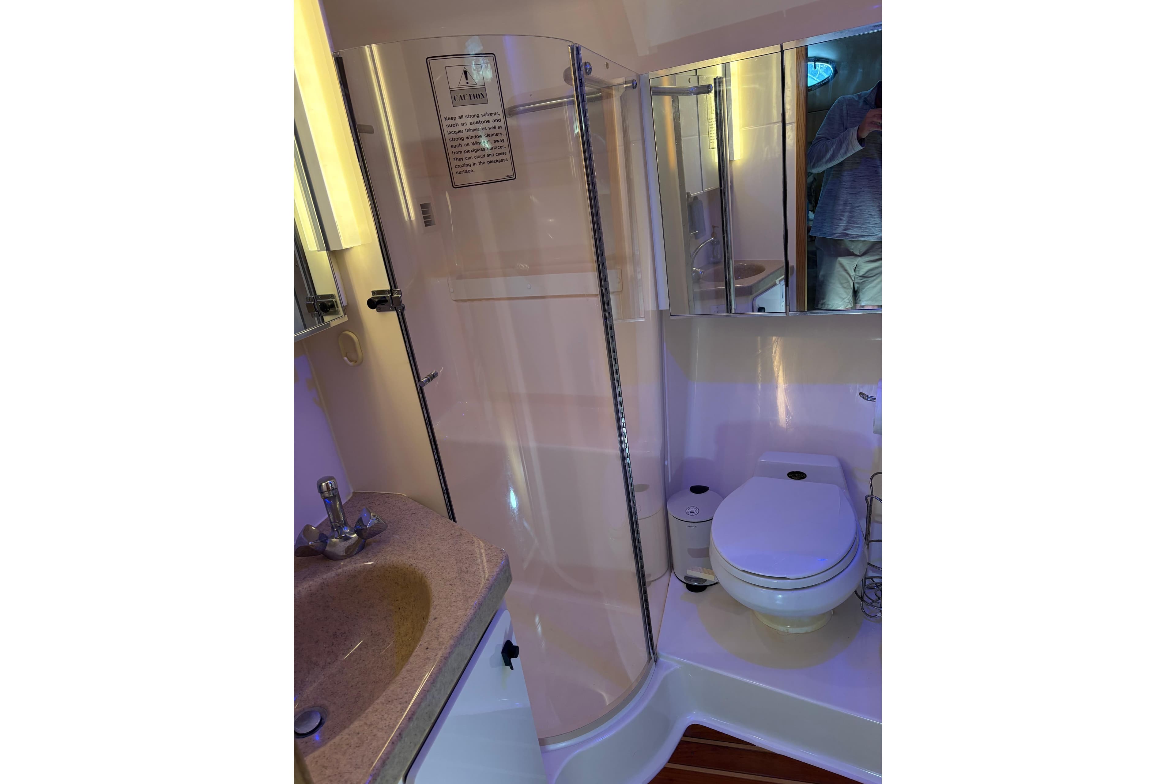 Bathroom interior of 1999 Tiara Yachts 4000 Express with shower, sink, and toilet.