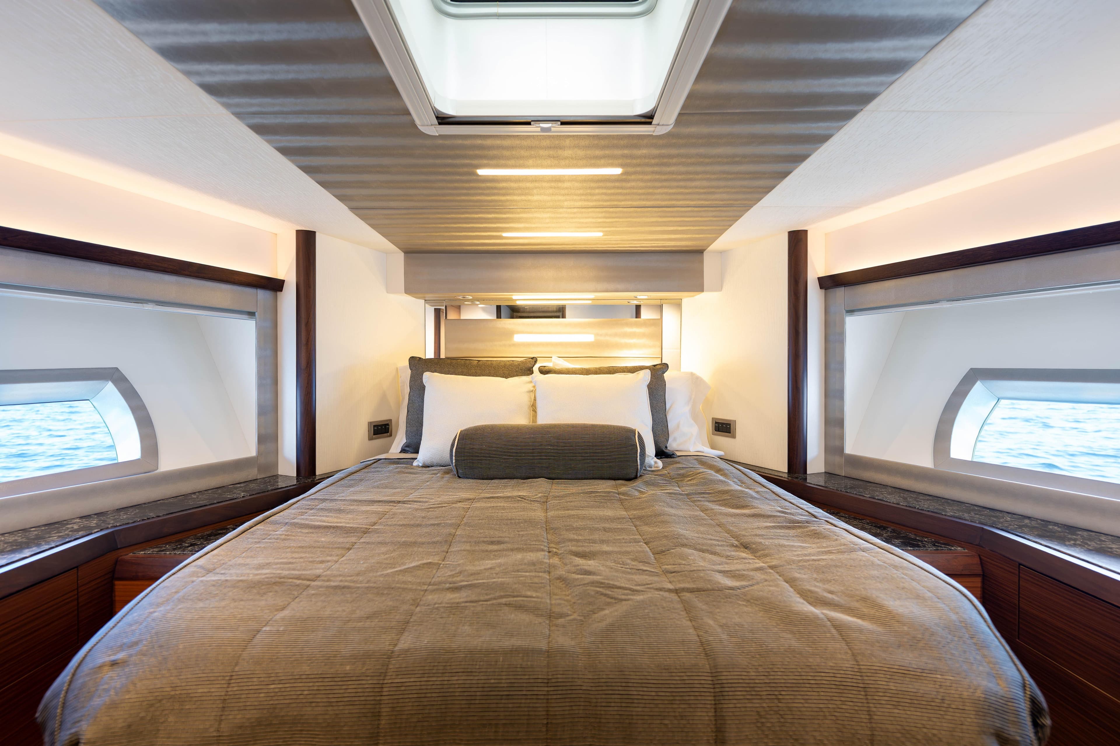 Luxurious bedroom interior of 2017 Ocean Alexander 70 E yacht with ocean view windows.