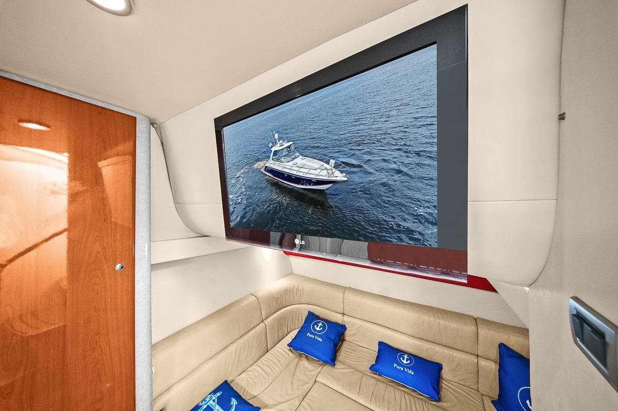 Interior of 2008 Formula 40 Performance Cruiser with TV and beige seating.