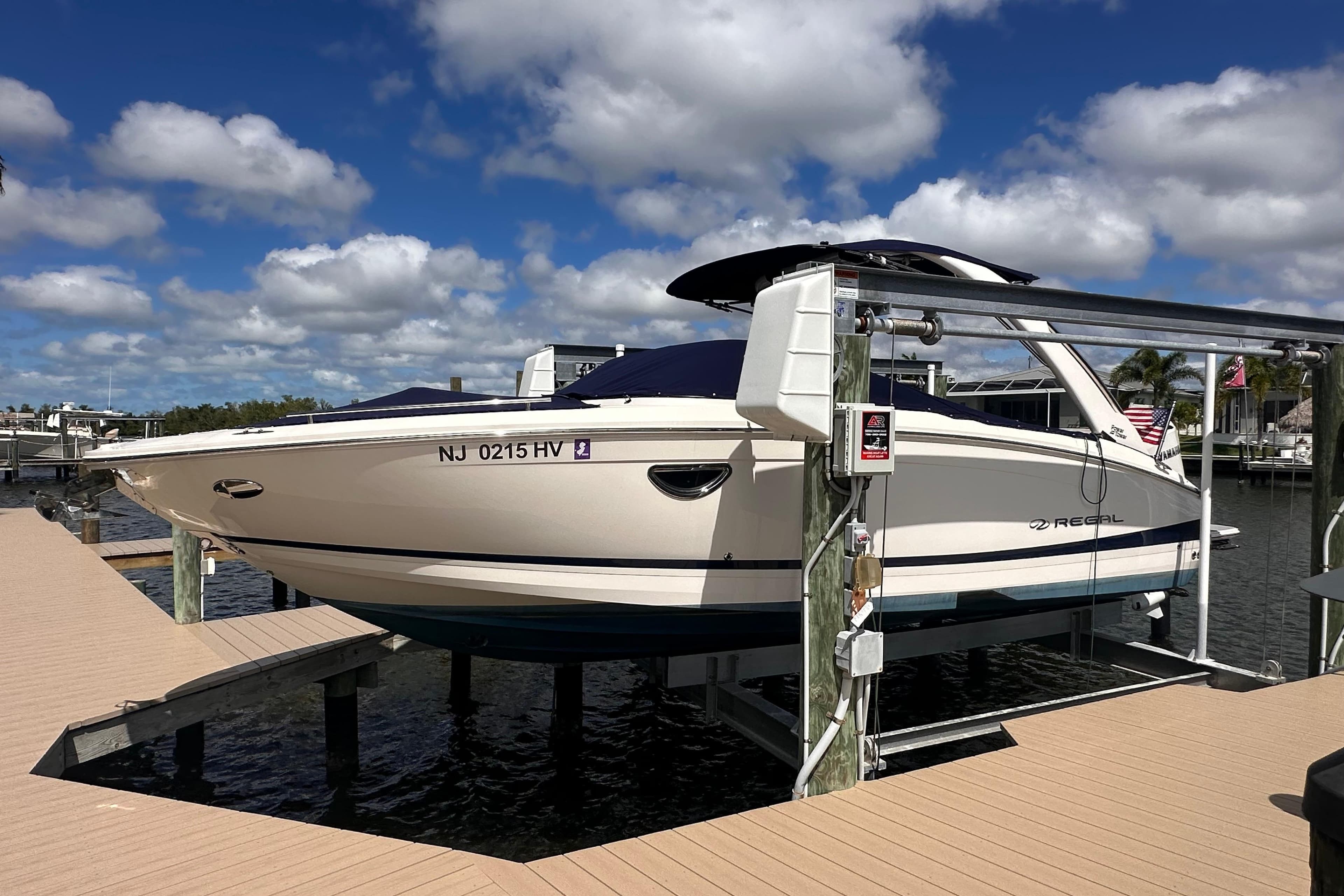 2025 Regal LX6 boat on a dock under sunny skies.