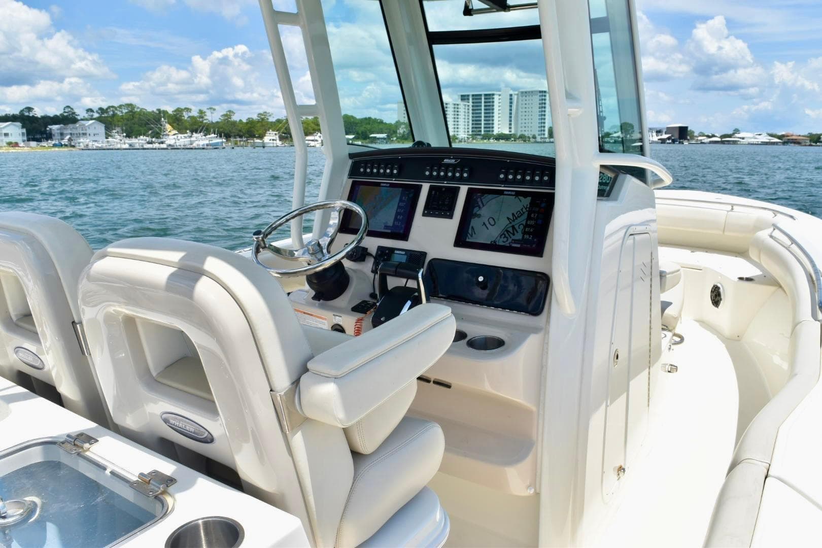 2023 Boston Whaler 280 Outrage boat interior with modern dashboard and steering wheel.