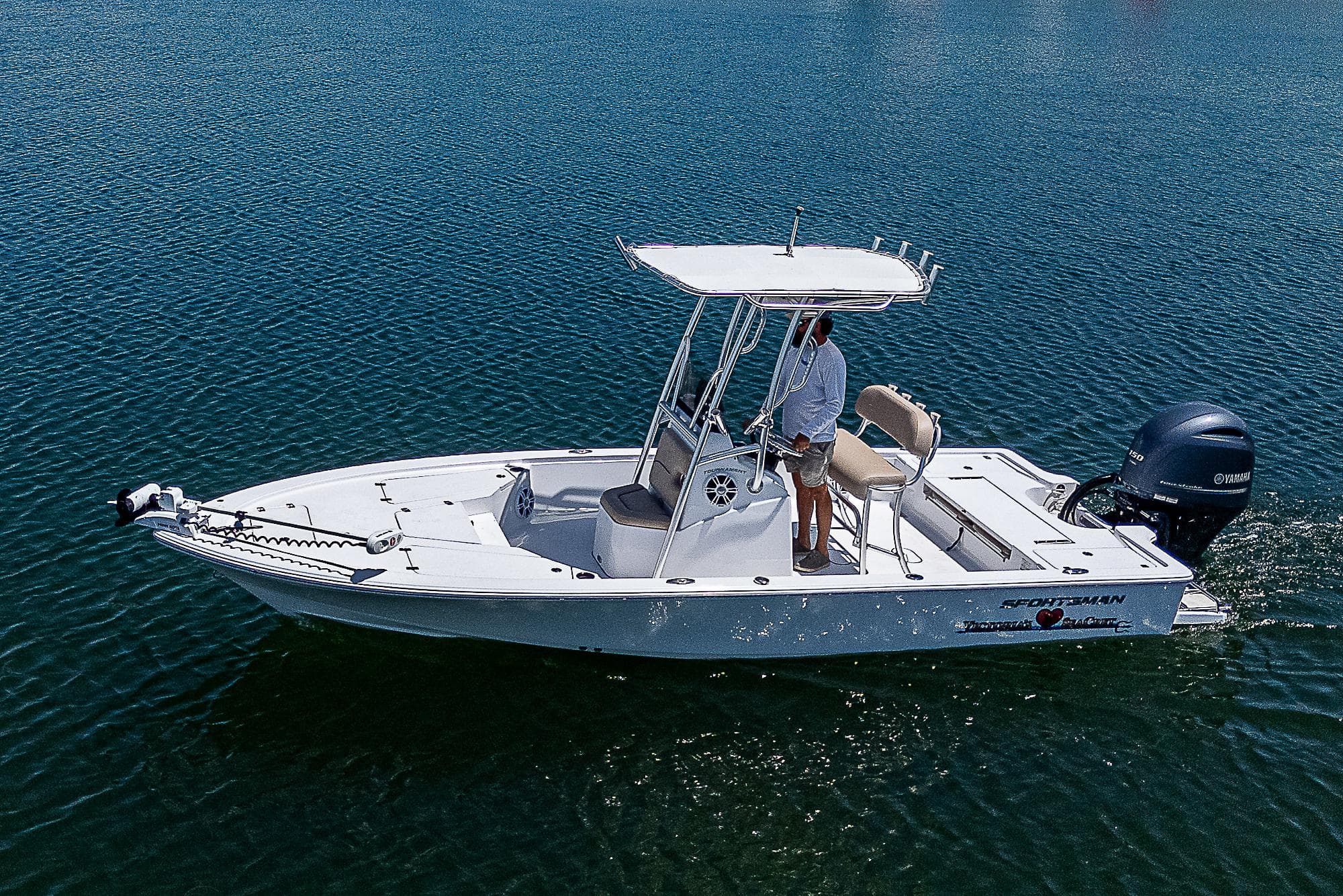 2020 Sportsman Tournament 214 Bay Boat on calm water, side view.