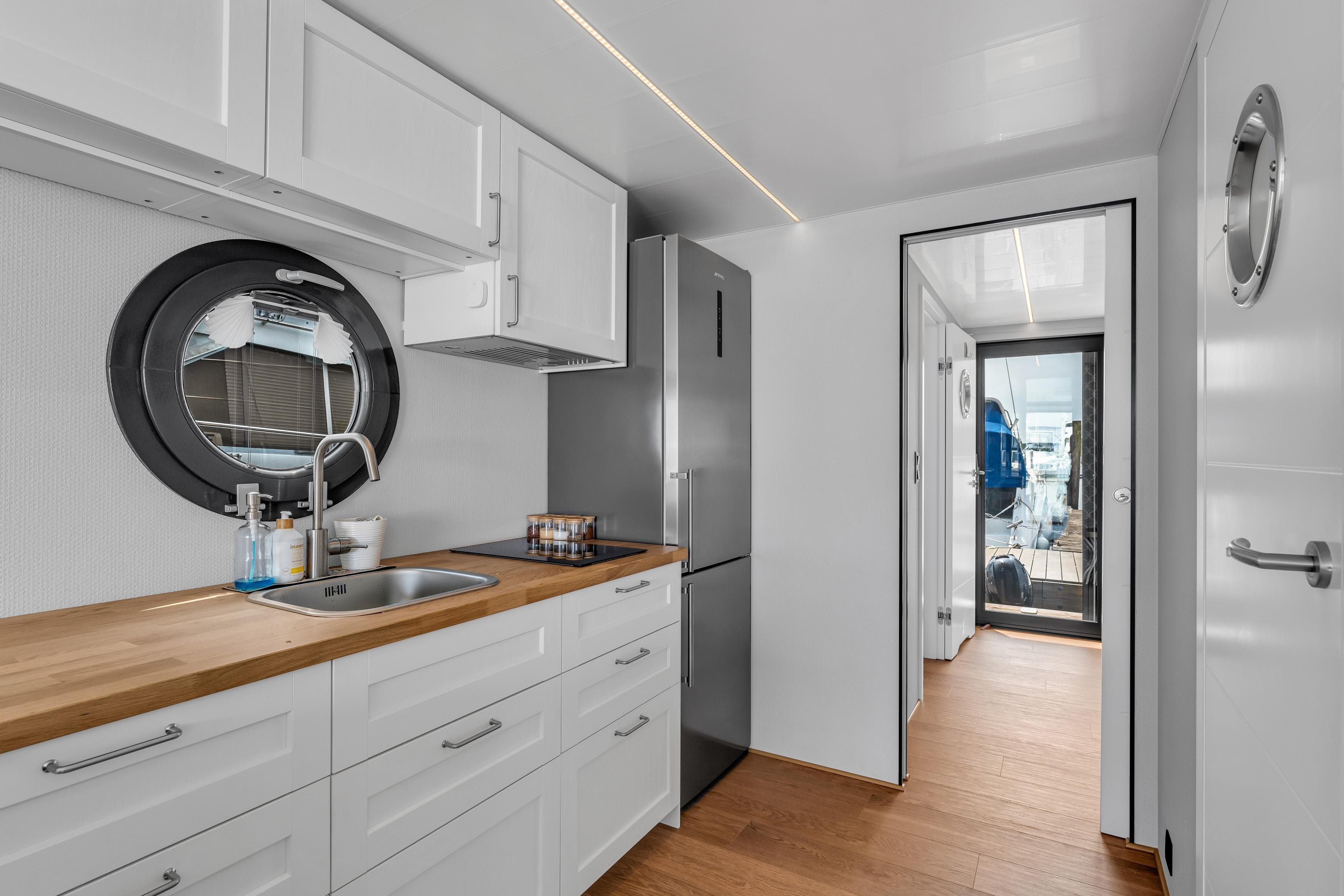 Modern kitchen interior of 2026 Waterlodge Apart L Long houseboat with sleek design.