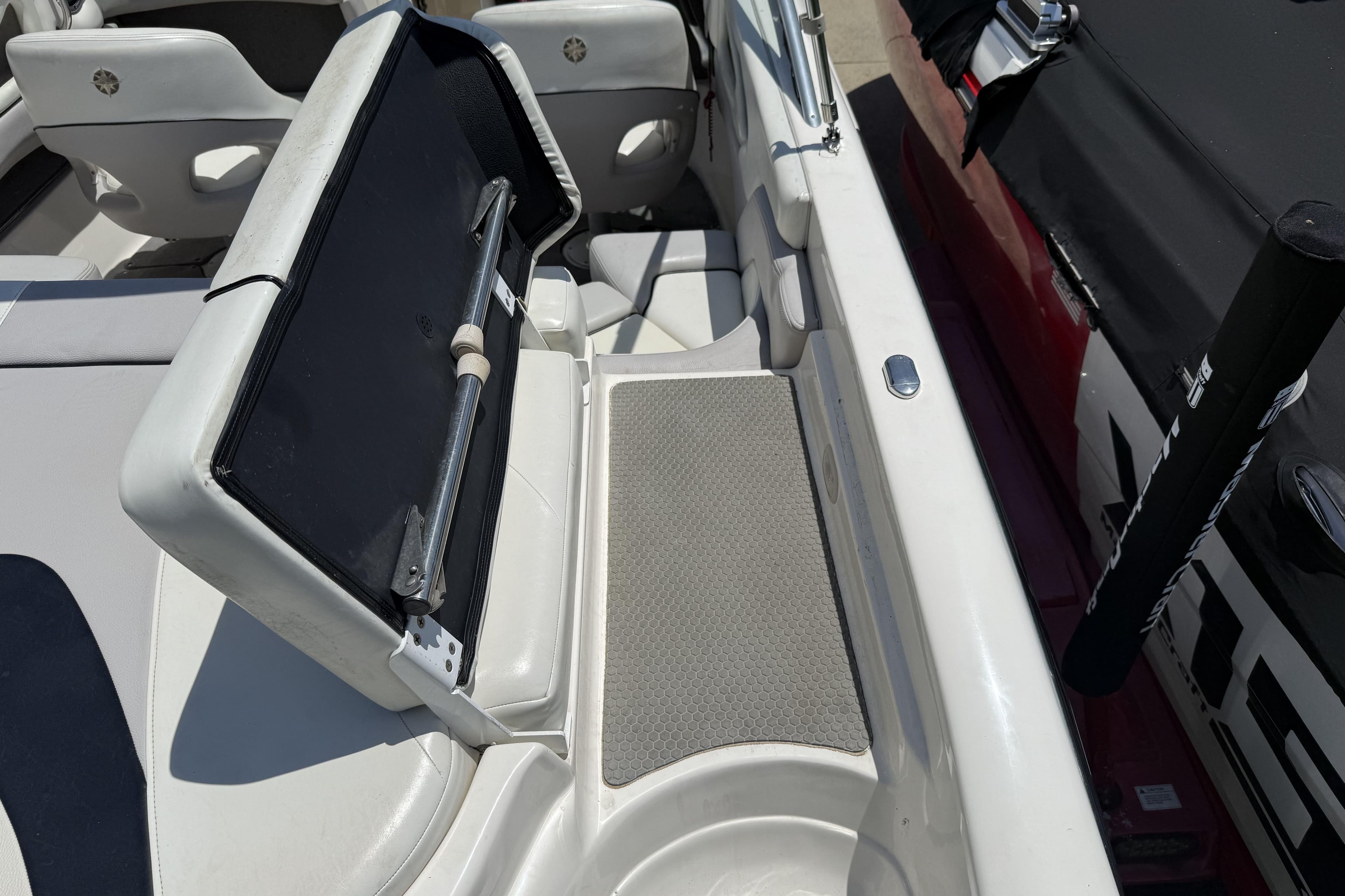 2010 Bryant 233 boat interior with open storage compartment and seating area.