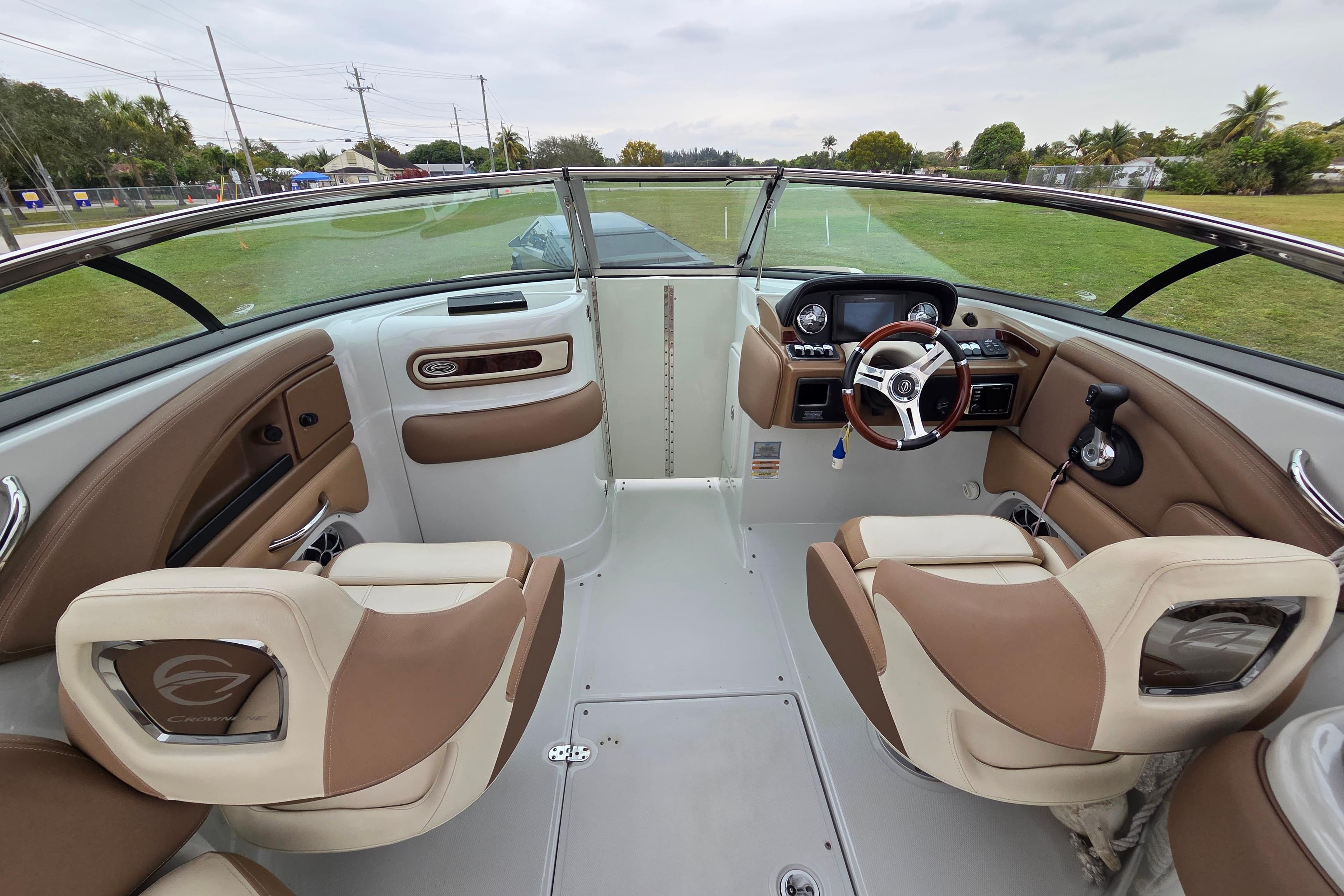 2019 Crownline Eclipse E275 XS boat interior with beige seating and modern dashboard.