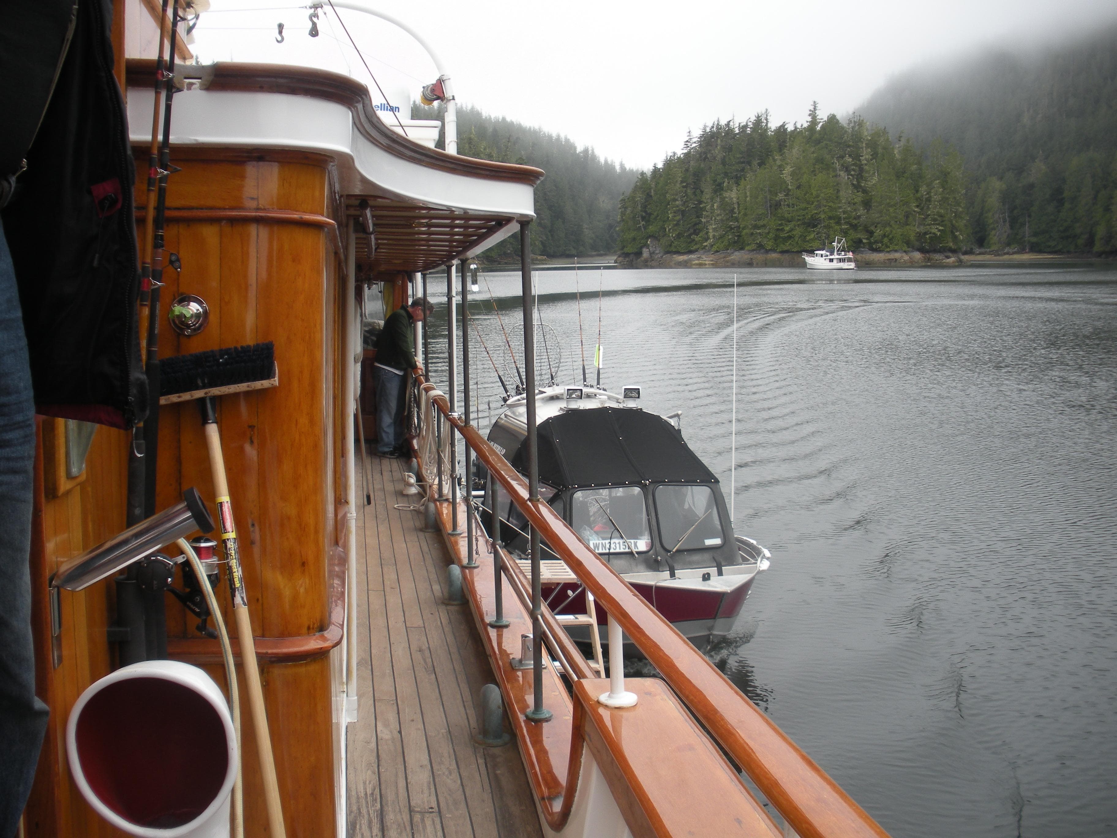 1929 Custom HOFFAR-BEECHING Fantail Yacht on serene water with forested background.