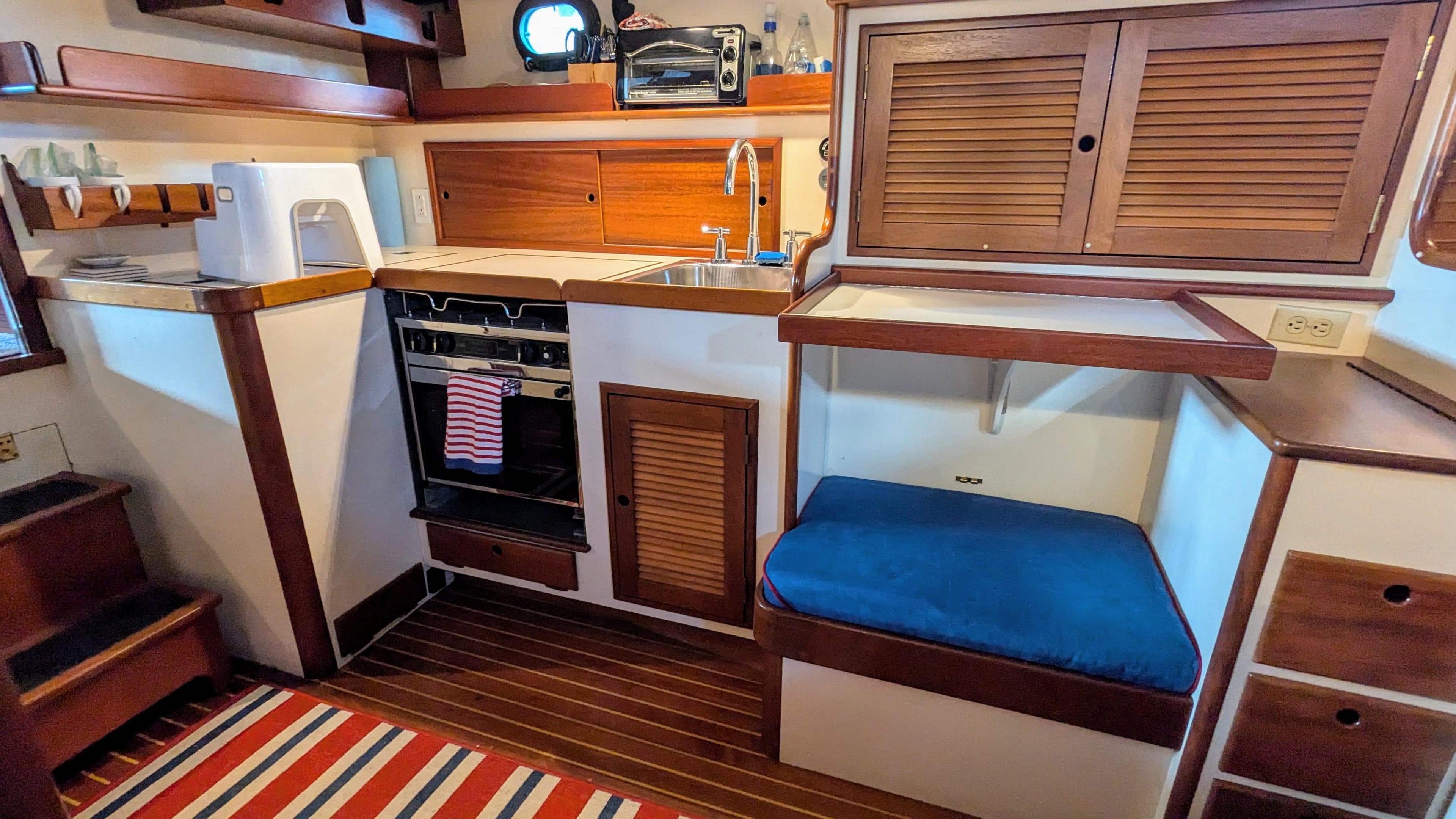 Interior of a 1990 Stanley Downeast Lobster Yacht with kitchen and seating area.