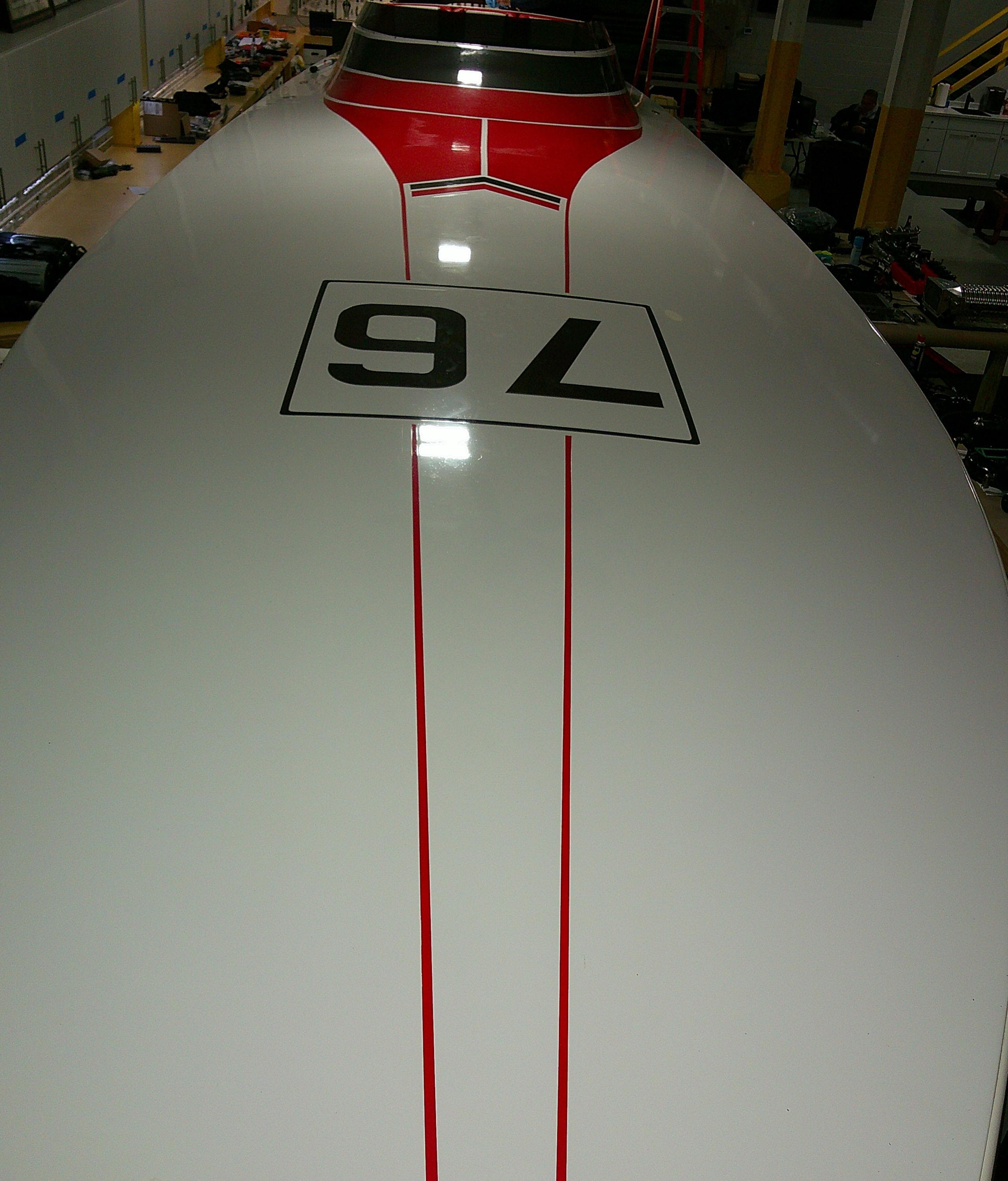 1993 Fountain 47 boat with red stripes and number 76 on deck.