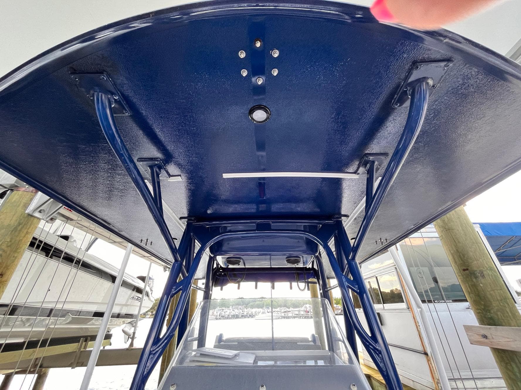 2011 Statement 380 Open boat, blue canopy, docked, view from below.