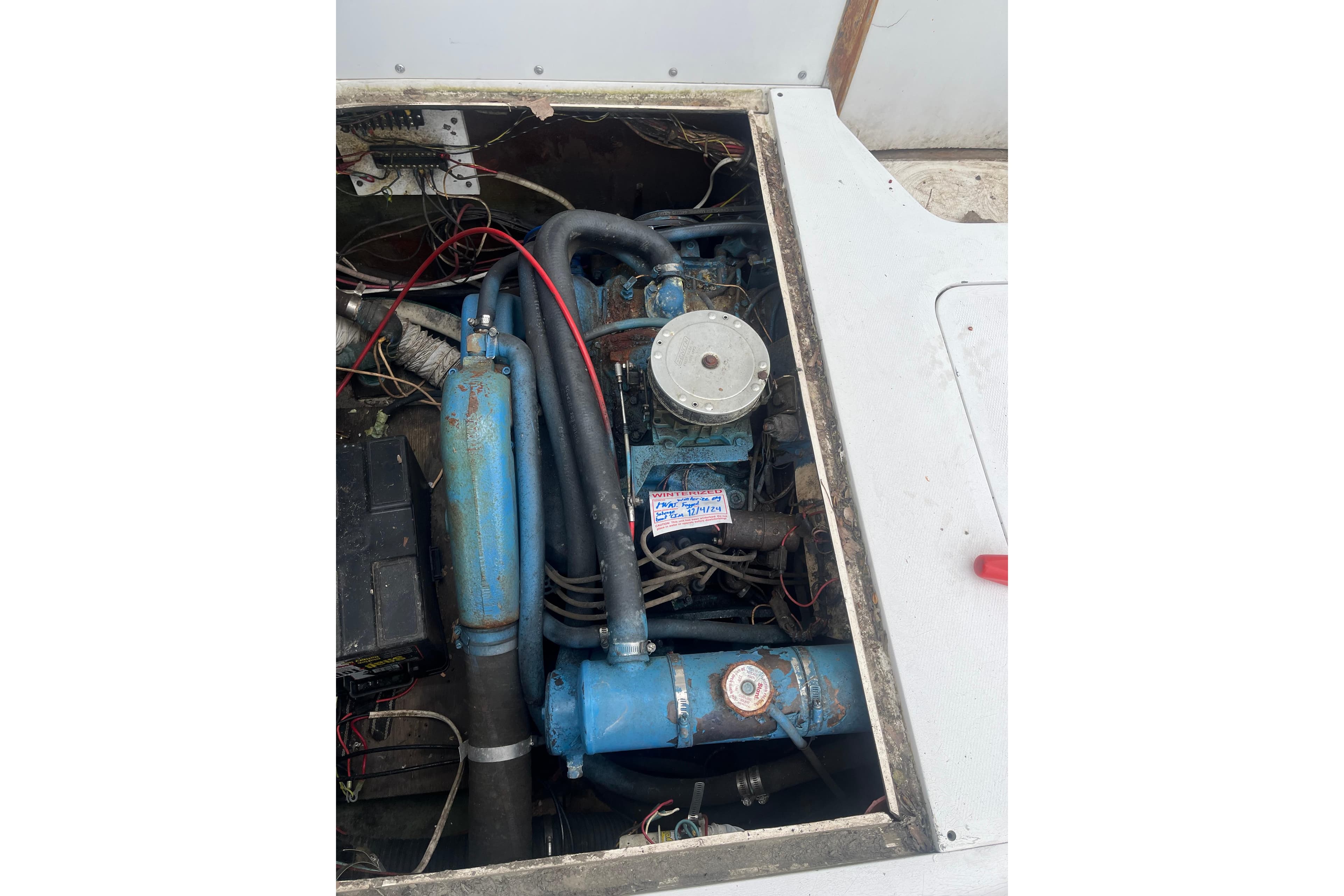 1973 Bertram 28 Flybridge Cruiser engine compartment with visible wiring and components.