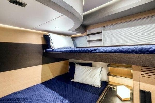 Luxurious 2021 OKEAN FB Motor Yacht cabin with modern bunk beds and elegant lighting.