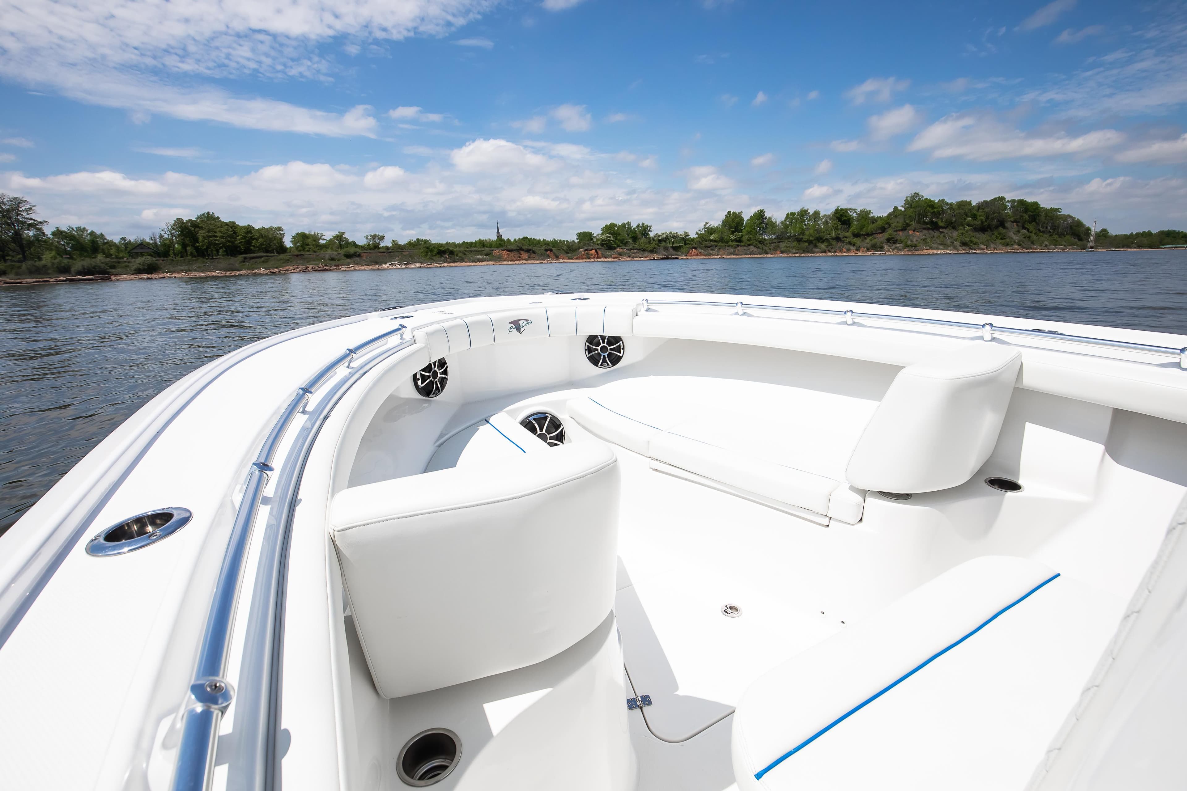 2025 Buddy Davis 28 Center Console boat on calm water, featuring sleek white seating.