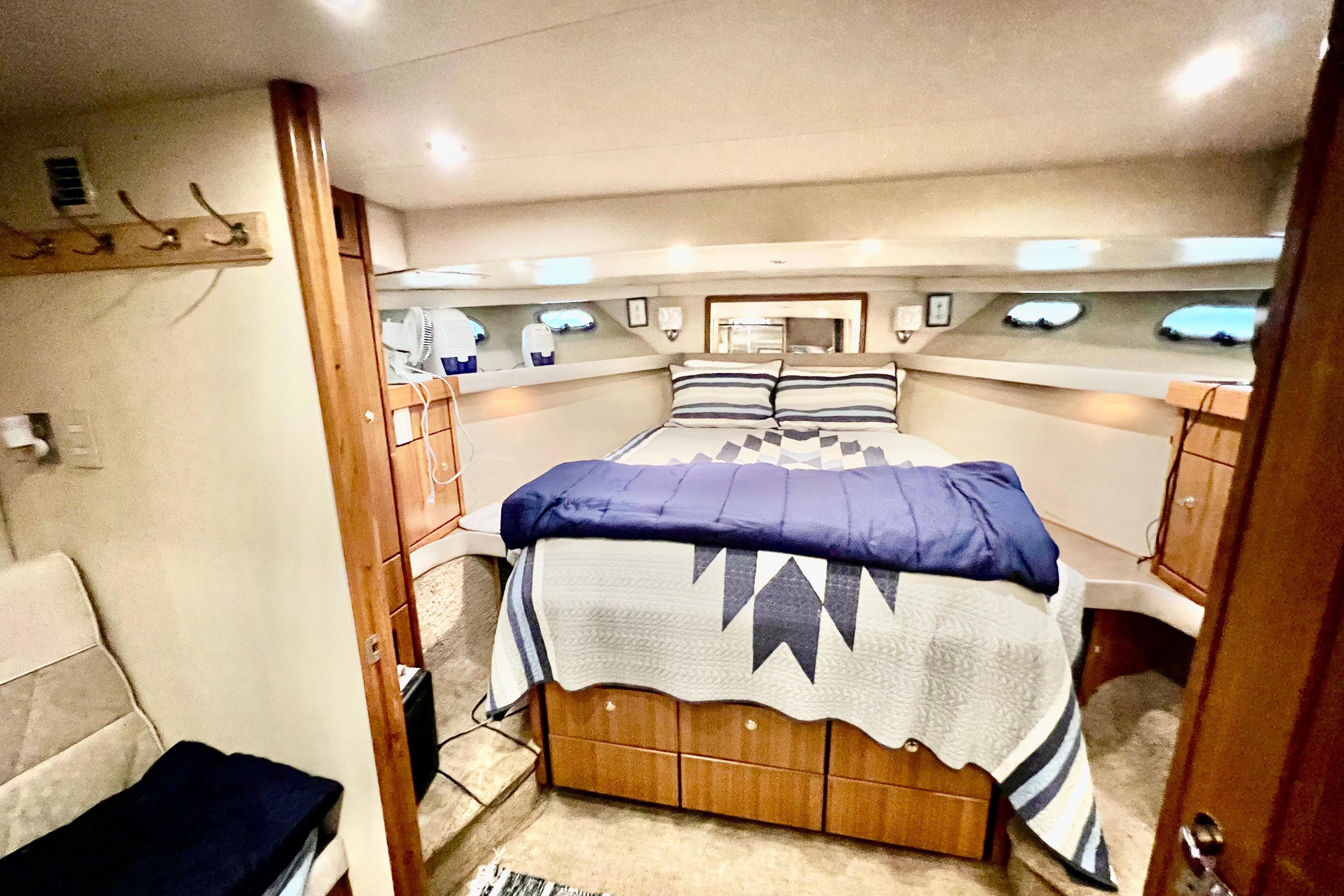 Interior of 2001 Bayliner 4788 Pilot House Motoryacht with cozy bedroom and nautical decor.