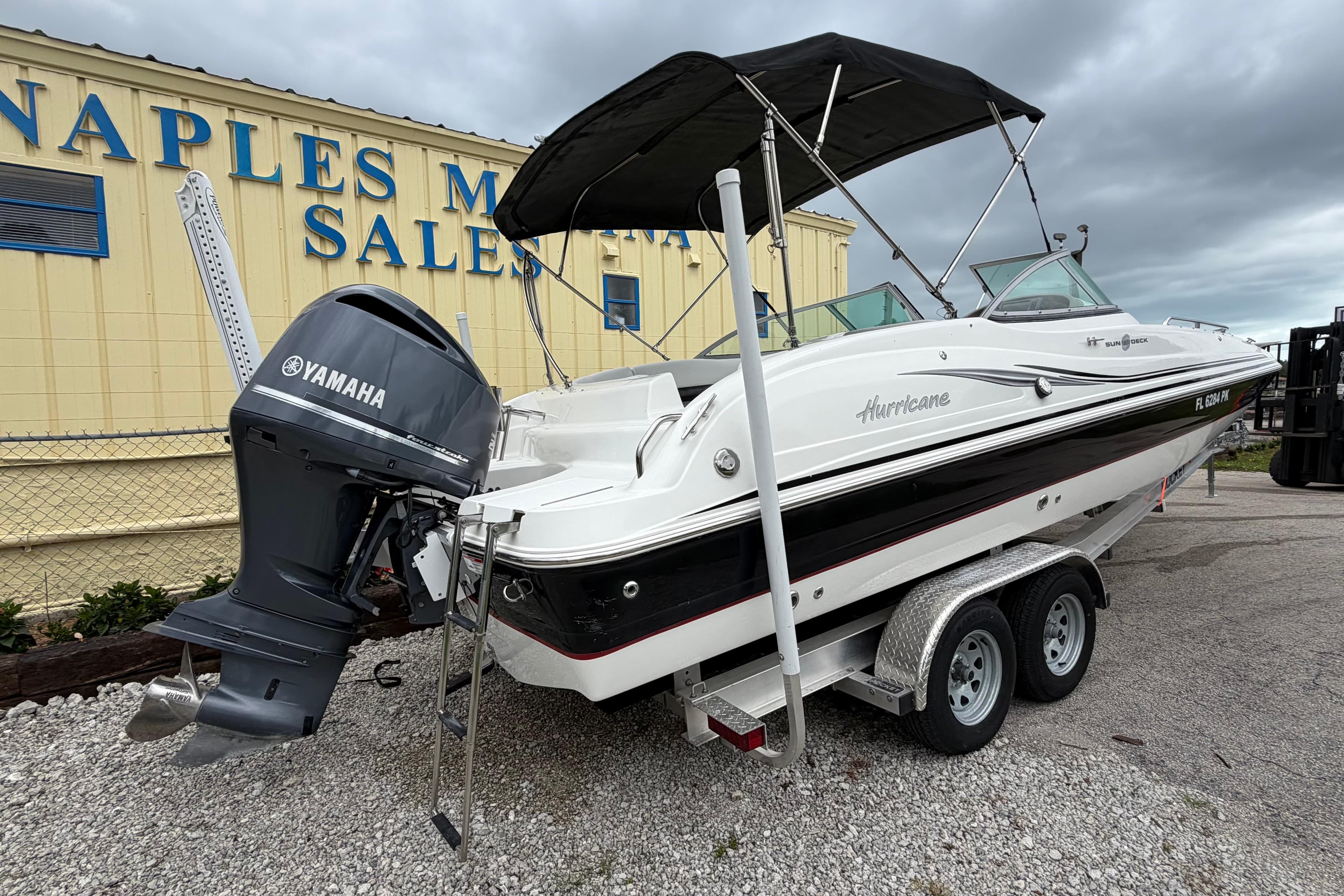 2013 Hurricane SunDeck 237 OB boat with Yamaha engine at marine sales.