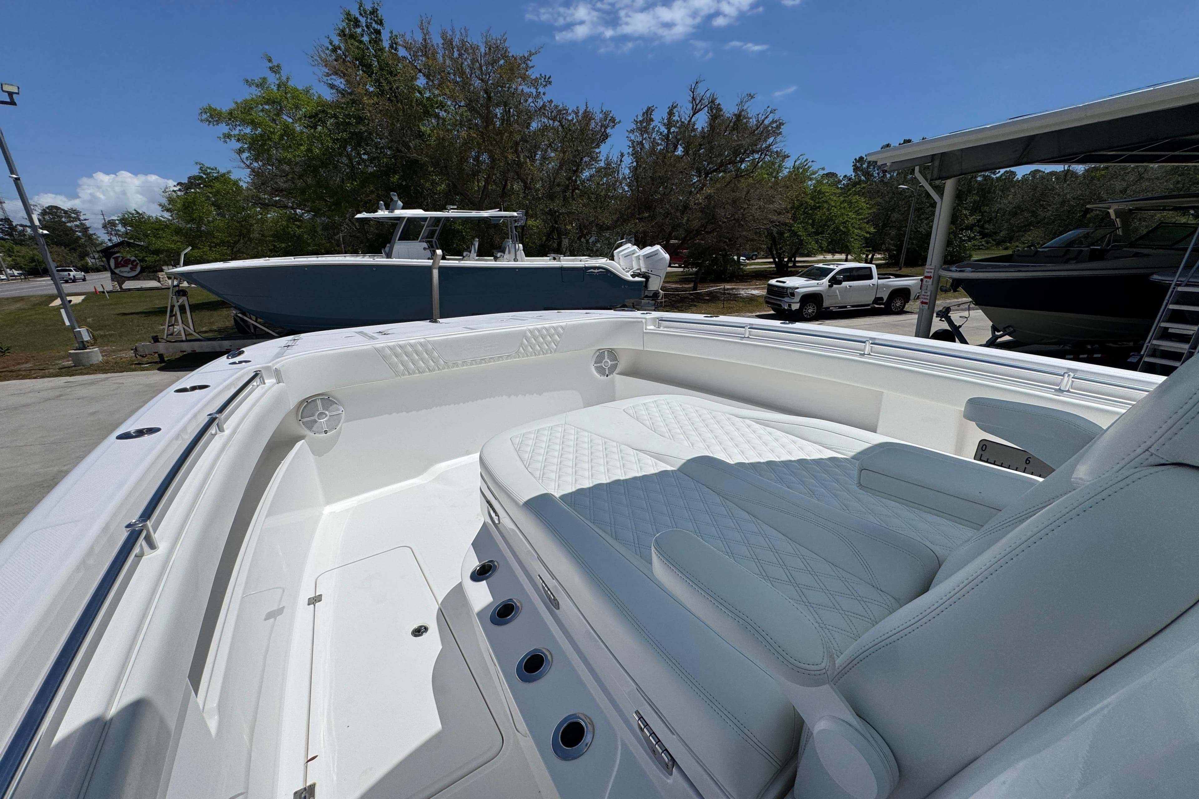 2024 Invincible 33 Catamaran with spacious seating, docked outdoors under clear skies.