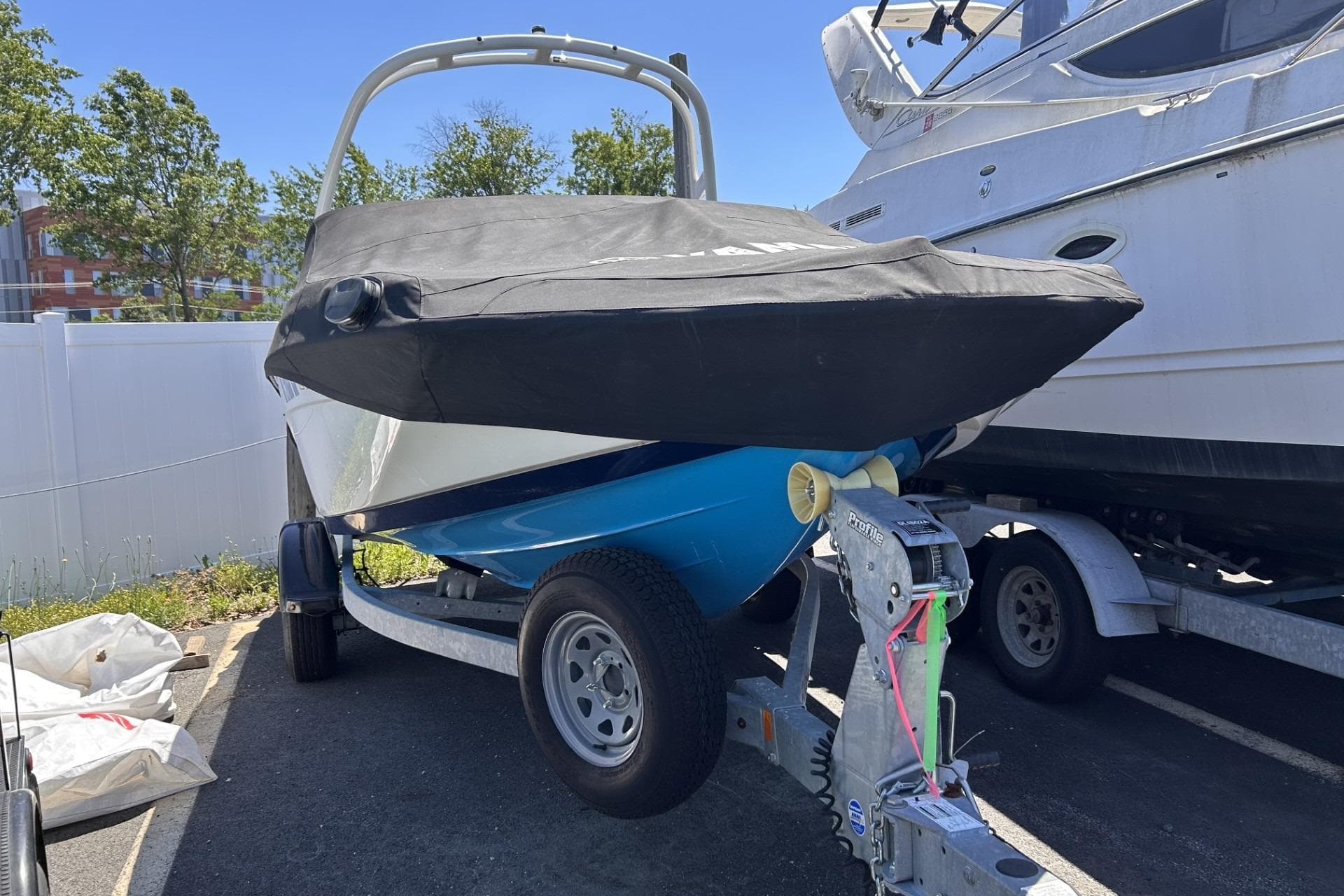 2021 Yamaha Boats AR190 on trailer, covered, parked outdoors.