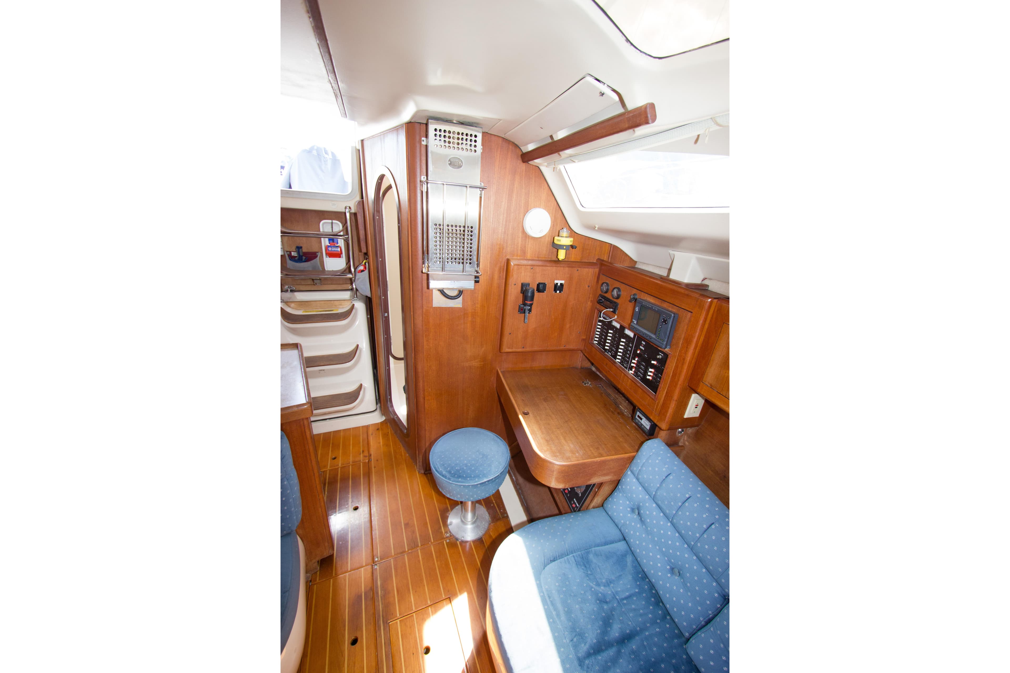 Interior of a 1997 Hunter 376 sailboat featuring wood paneling and navigation station.