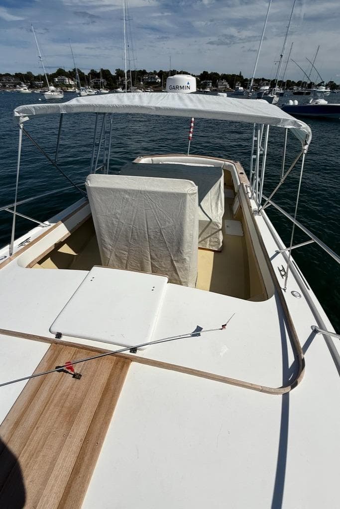 1986 Dusky 26 Custom boat with canopy, docked in a marina, featuring Garmin equipment.