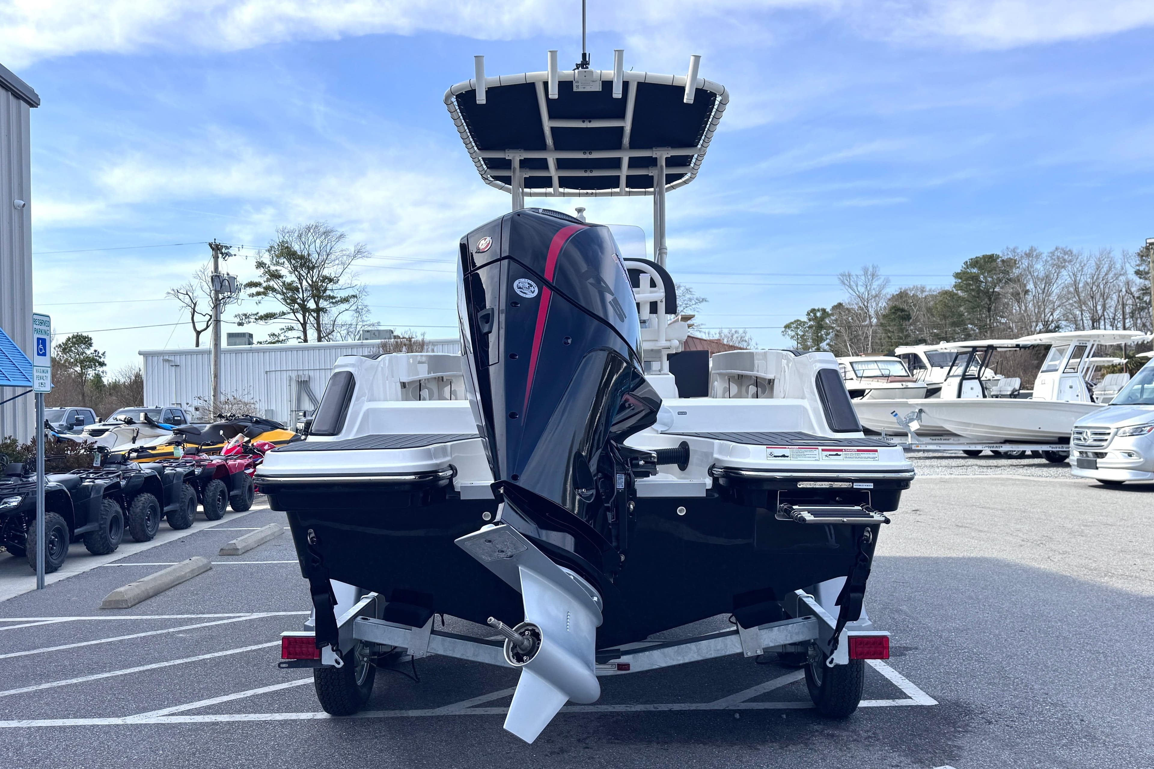 2026 Trophy CC20 boat on trailer, rear view with outboard motor, parked in marina lot.