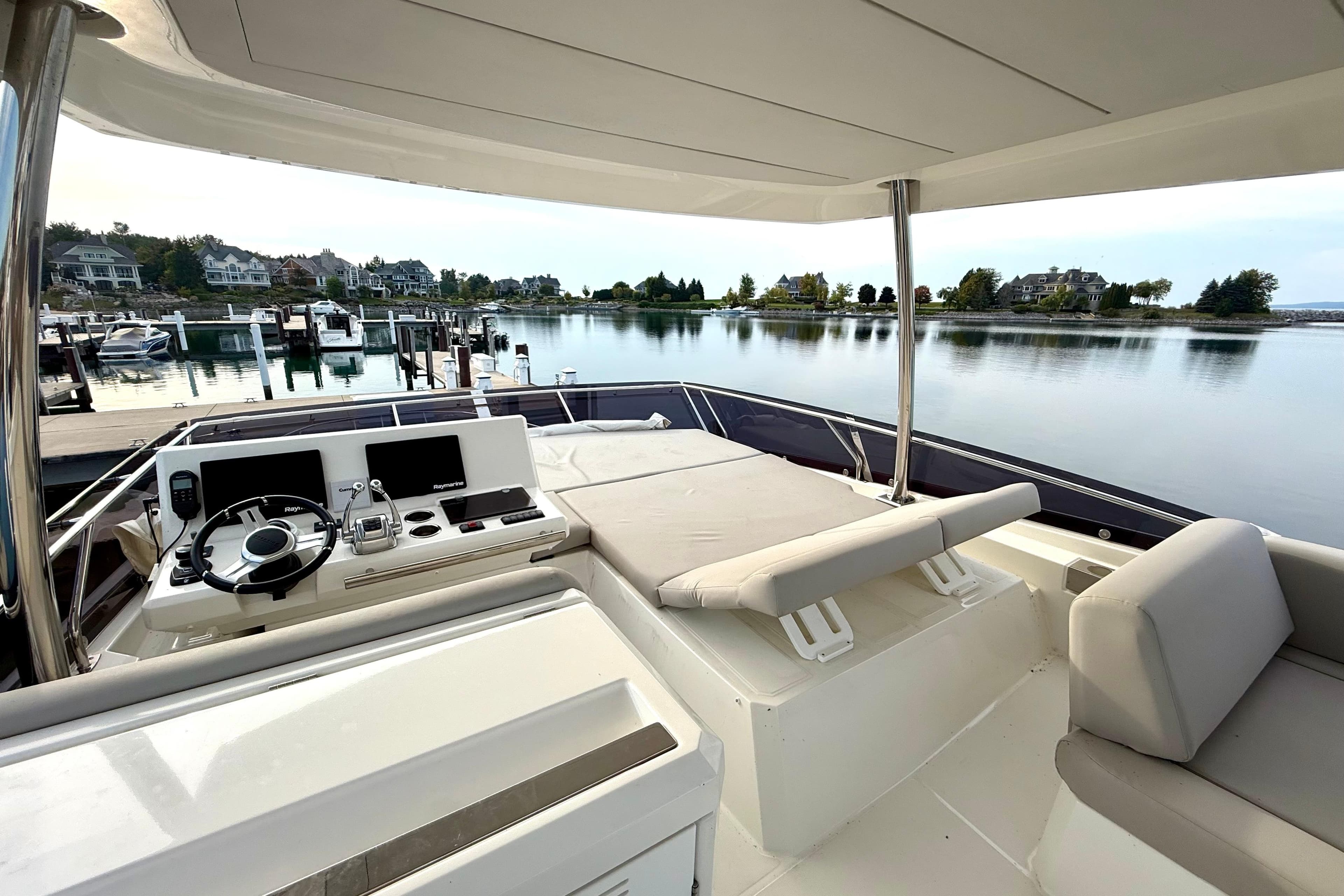 Luxurious 2020 Prestige 590 yacht interior with serene waterfront view.