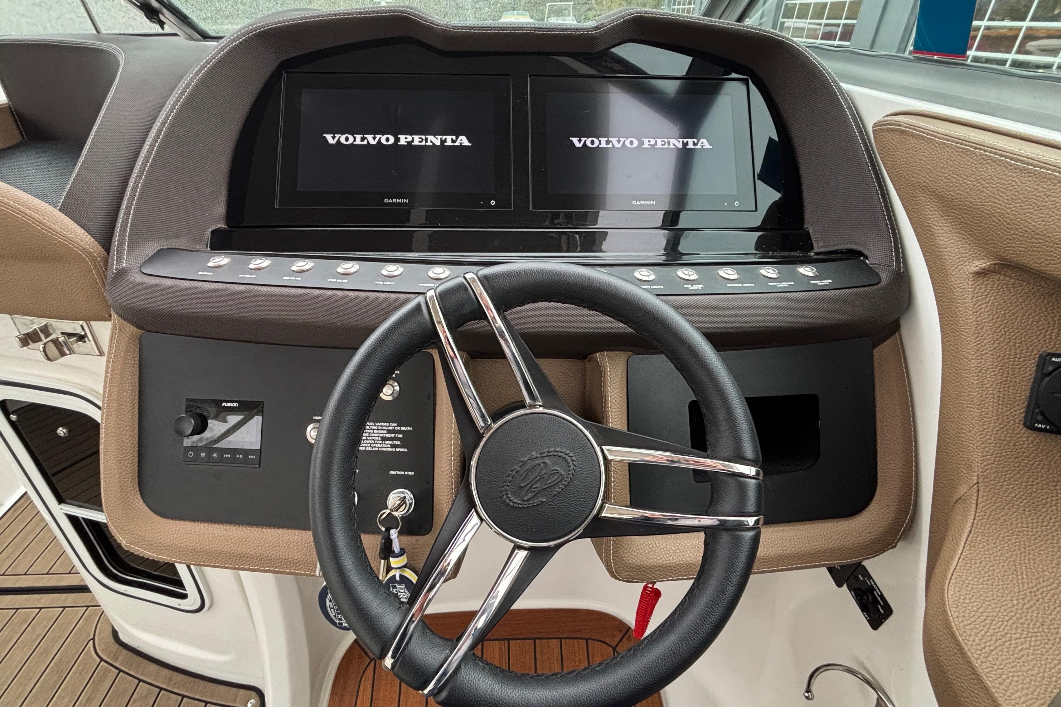 Steering wheel and dashboard of 2022 Cobalt R35 boat with Volvo Penta displays.