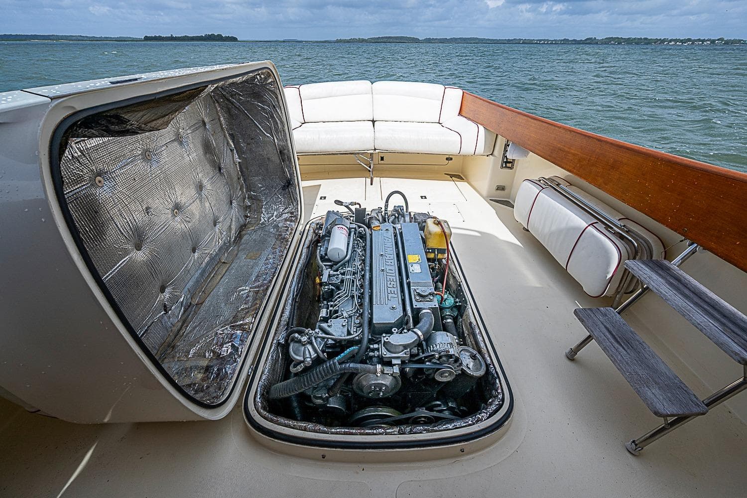Hinckley Picnic Boat 36 Classic 1996 engine compartment with open hatch, docked on calm water.
