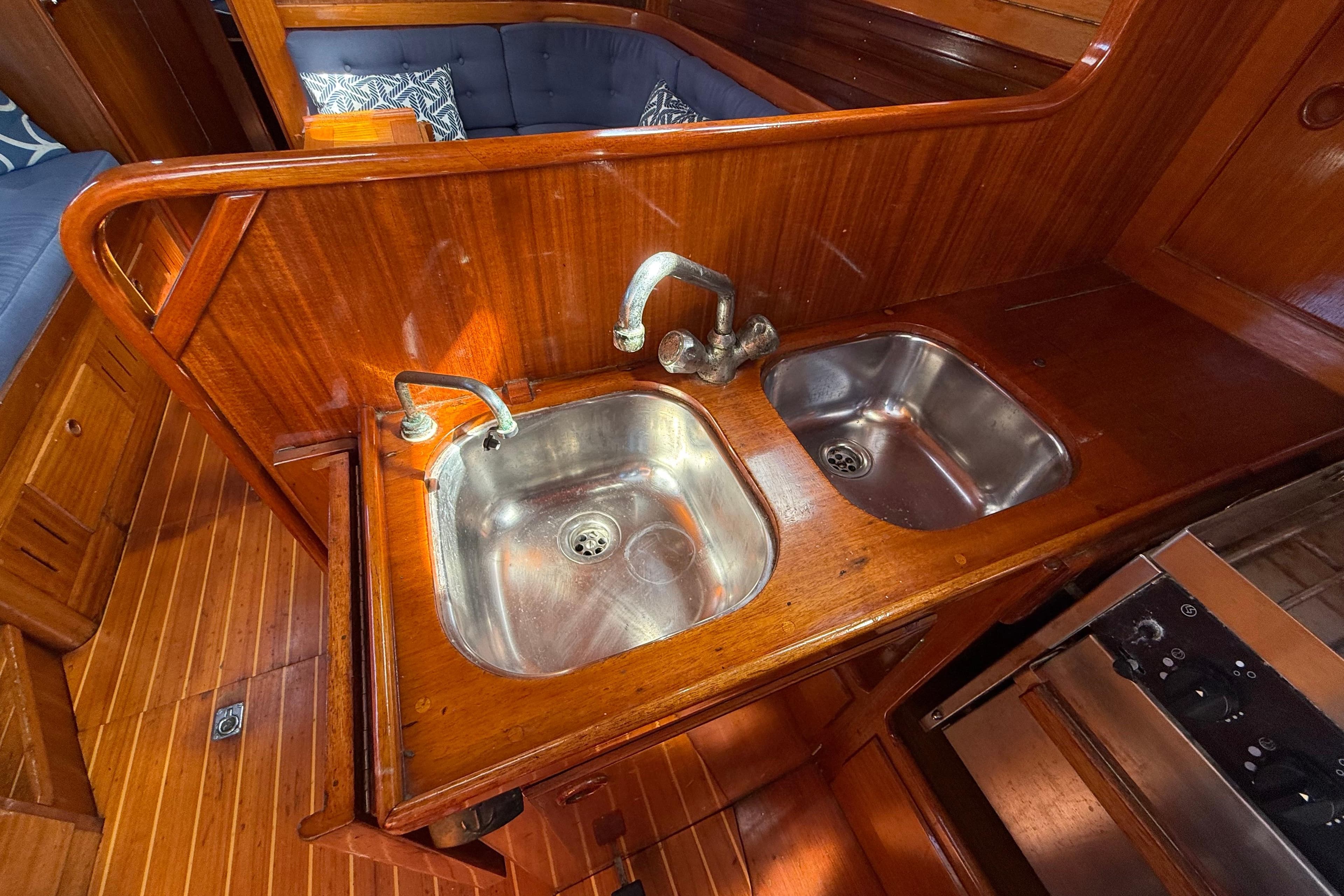 Wooden interior of 1986 Vindo 45 yacht with dual stainless steel sinks.