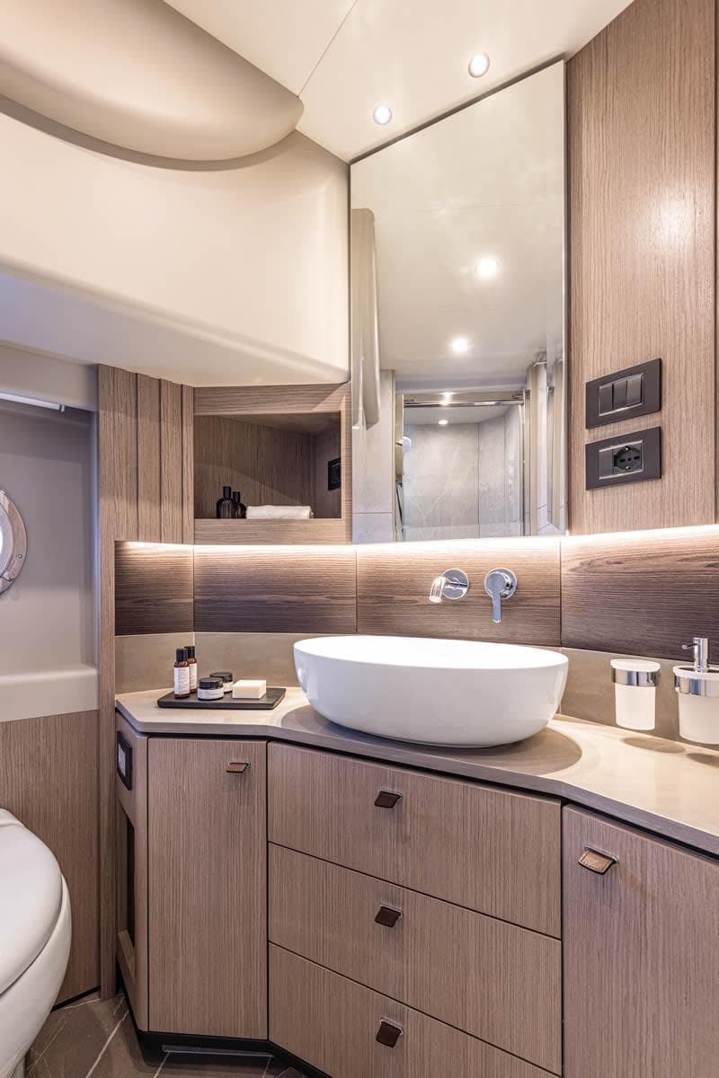 Luxurious bathroom in 2025 Absolute 53 Navetta yacht with modern fixtures and elegant design.