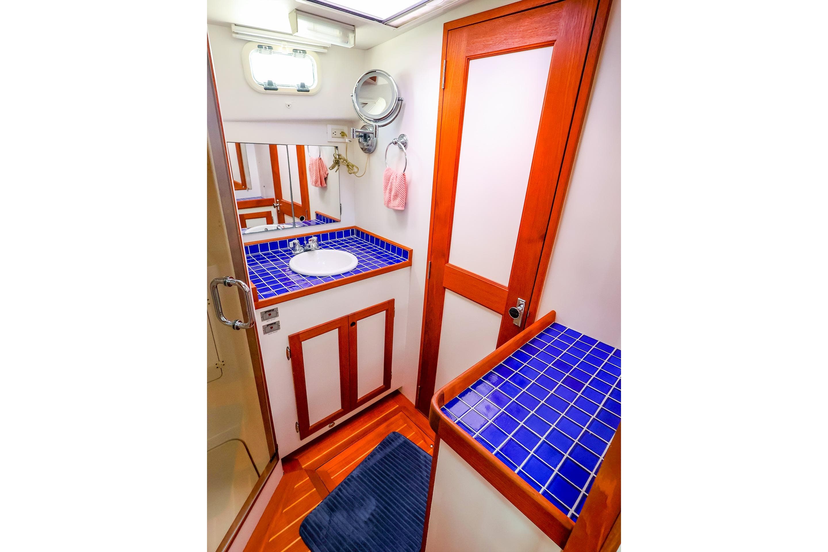 Luxurious 2005 New England Boatworks Downeast Sedan bathroom with blue tiled countertop.