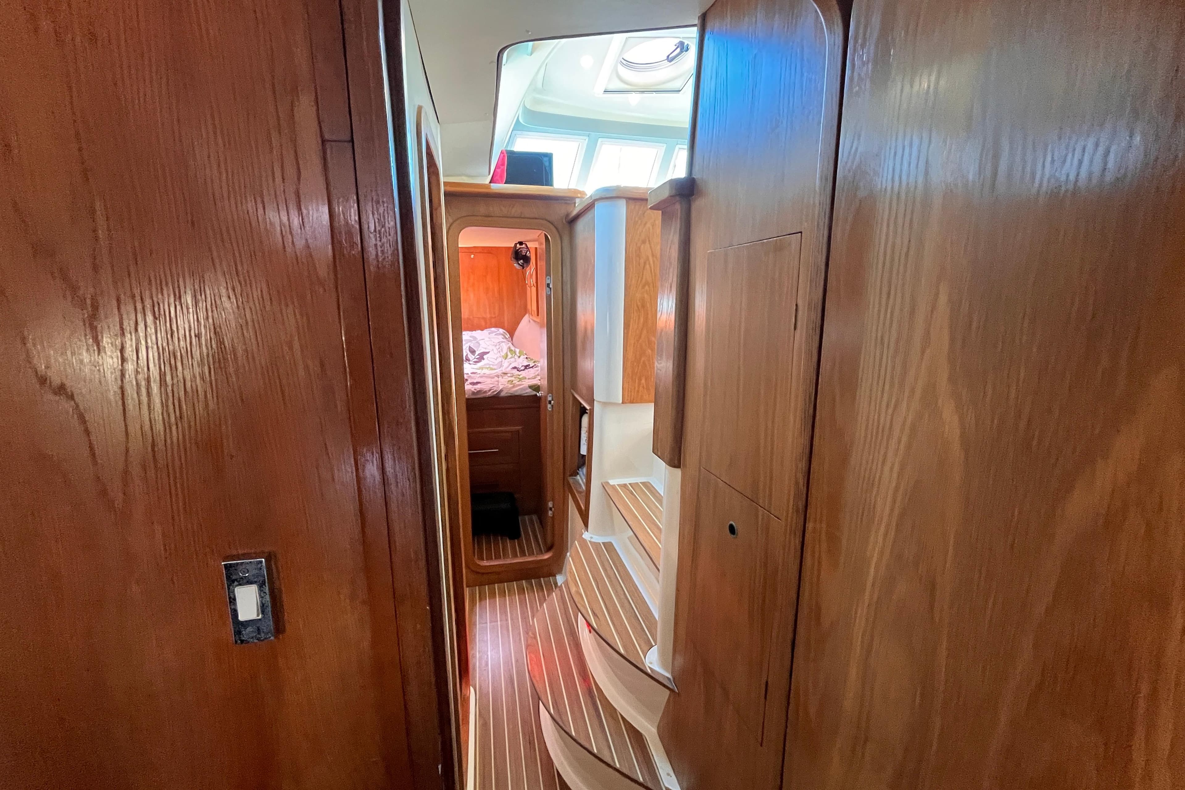 Interior of 2008 Broadblue 415 yacht with wooden paneling and cozy cabin.