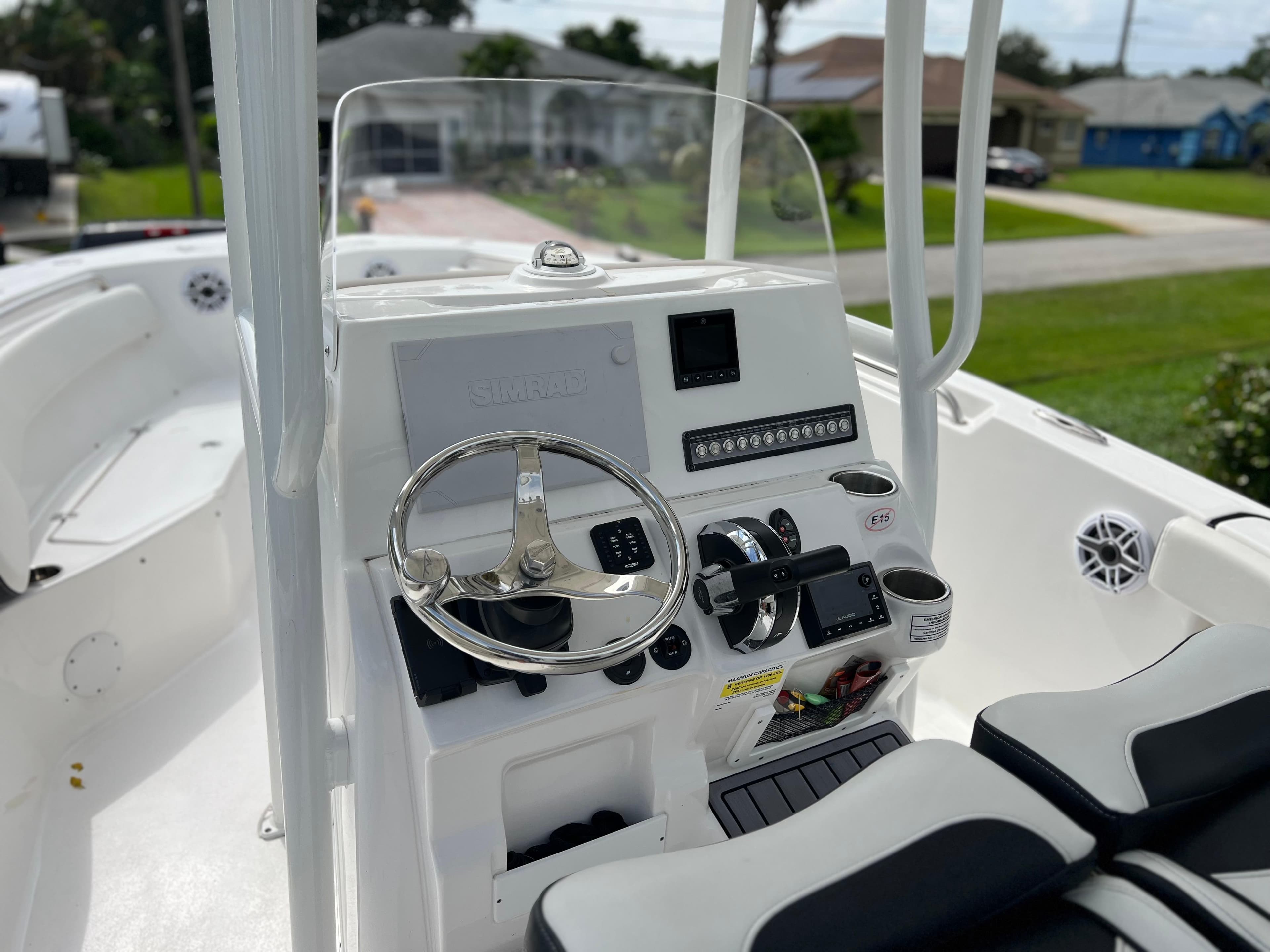 2023 Tidewater 220 CC Adventure boat cockpit with steering wheel and control panel.