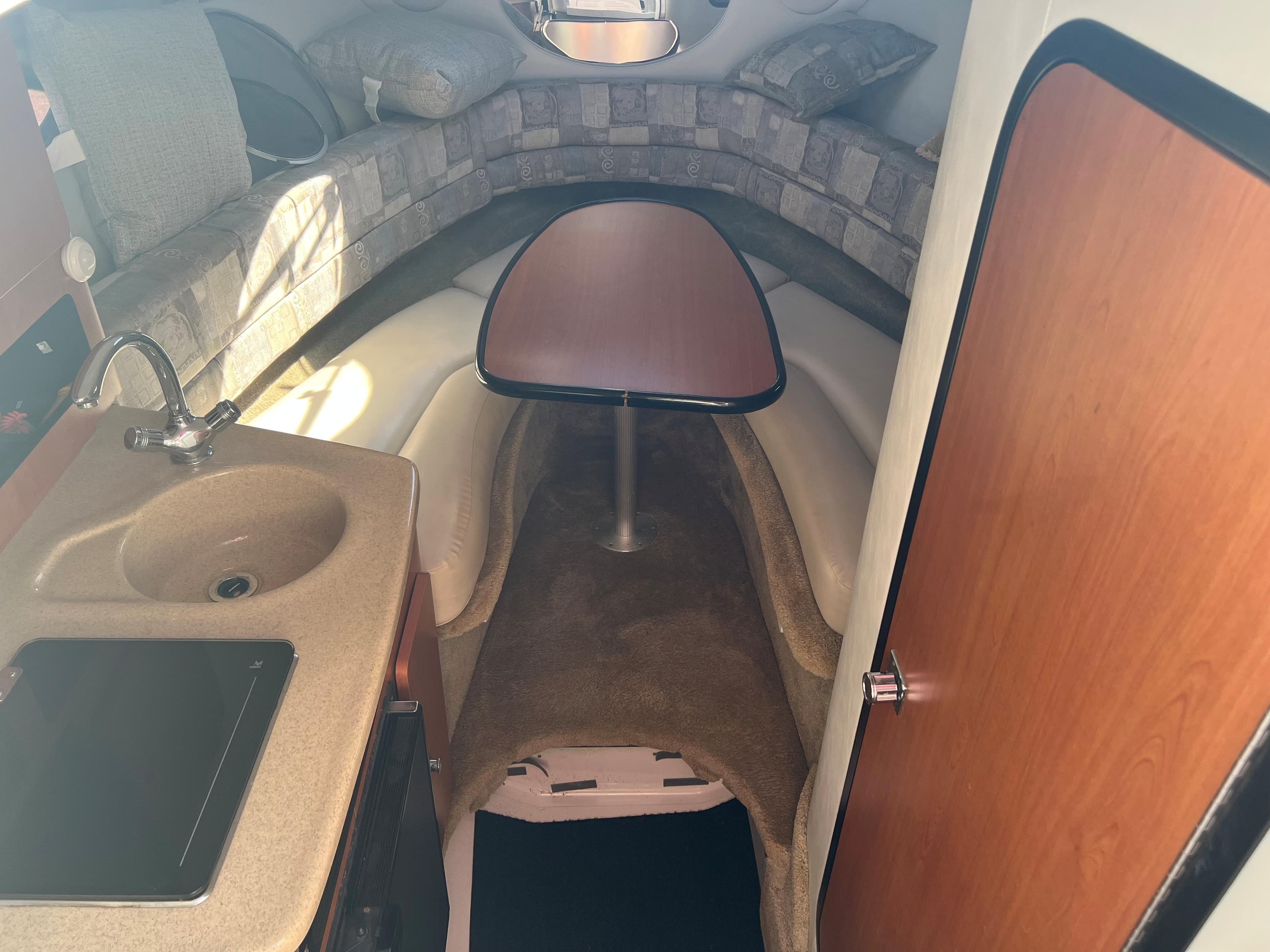 2007 Crownline 250 CR cabin interior with kitchenette and seating area.