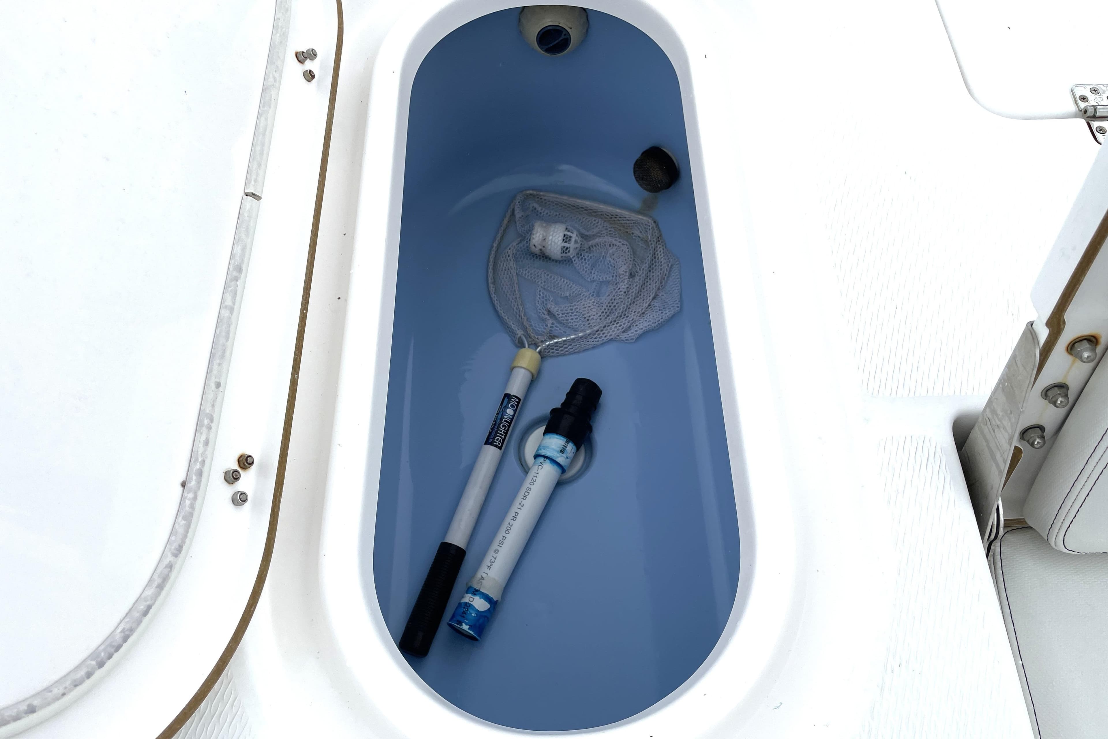 Livewell in 2019 Blue Wave 2800 Pure Hybrid boat with fishing net and tools.