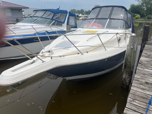 1997 Monterey 296 Cruiser docked at marina, featuring sleek design and spacious deck.