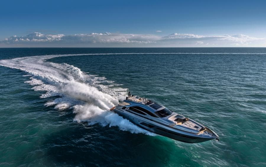 2024 Pershing 8X yacht cruising swiftly on open ocean under clear skies.