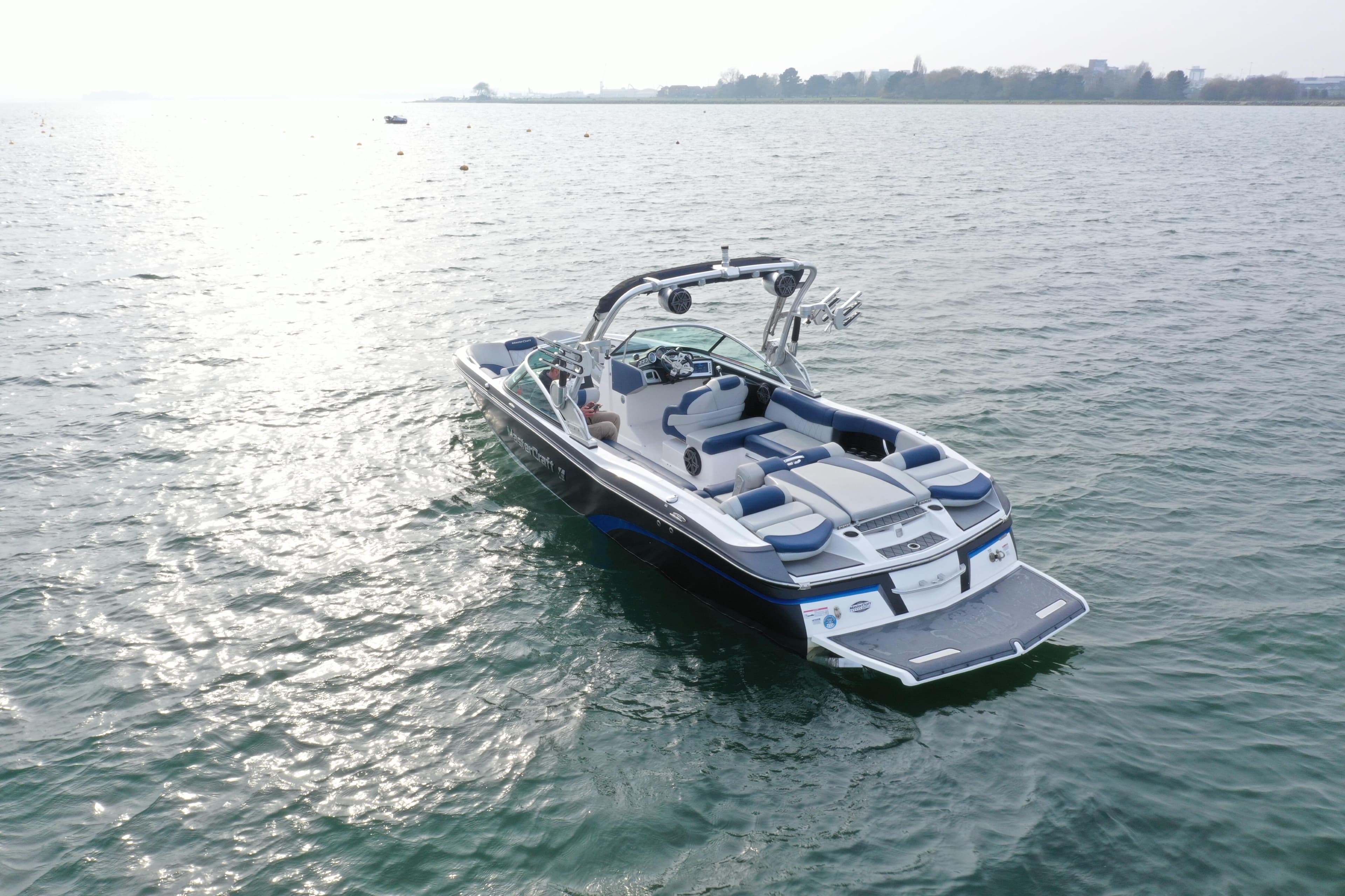 2015 MasterCraft X46 boat on calm water, showcasing sleek design and spacious seating.