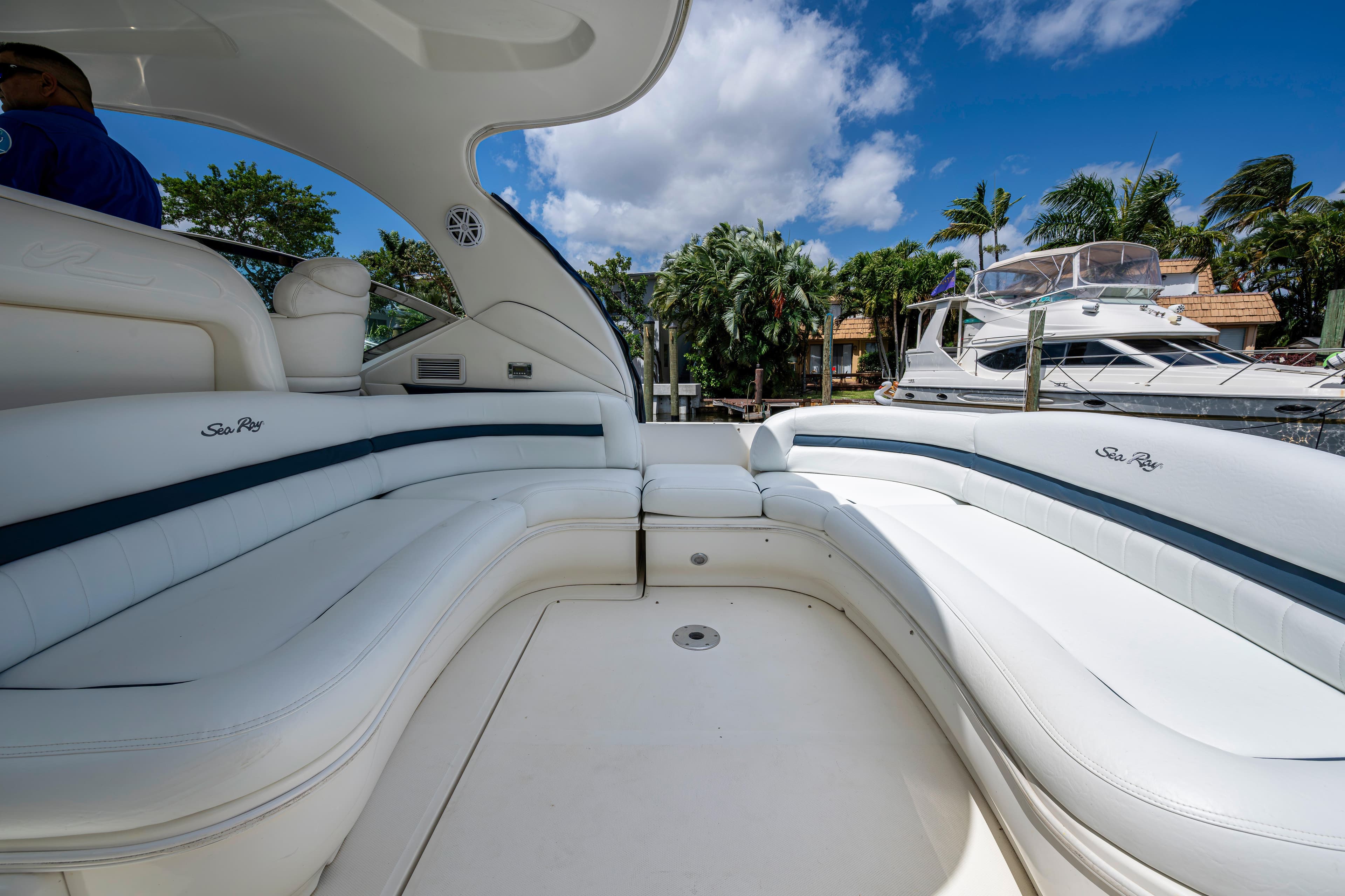 Luxurious 2005 Sea Ray 420 Sundancer yacht interior with white seating and blue accents.