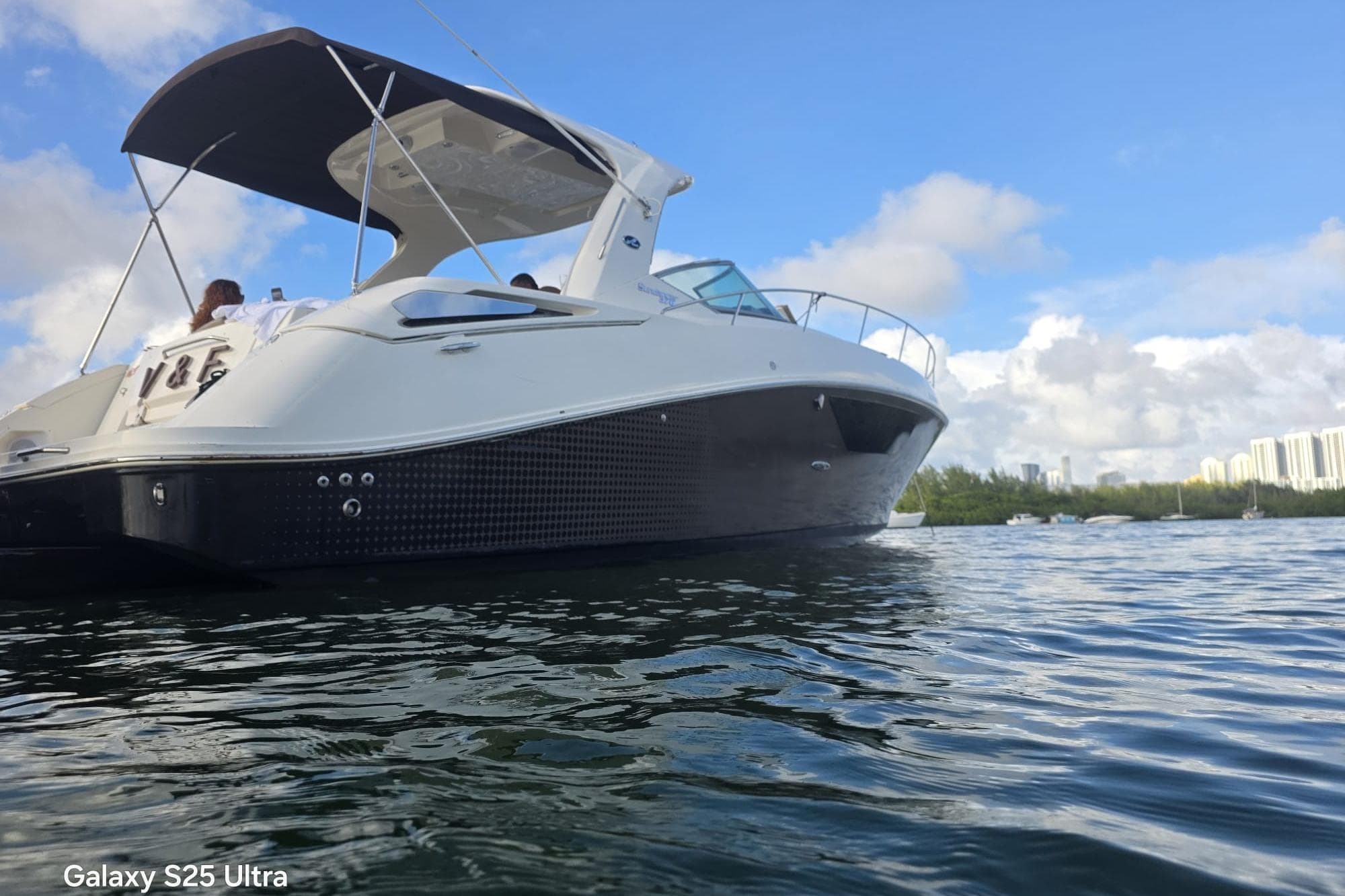 2010 Sea Ray 370 Sundancer yacht on calm water under blue sky.