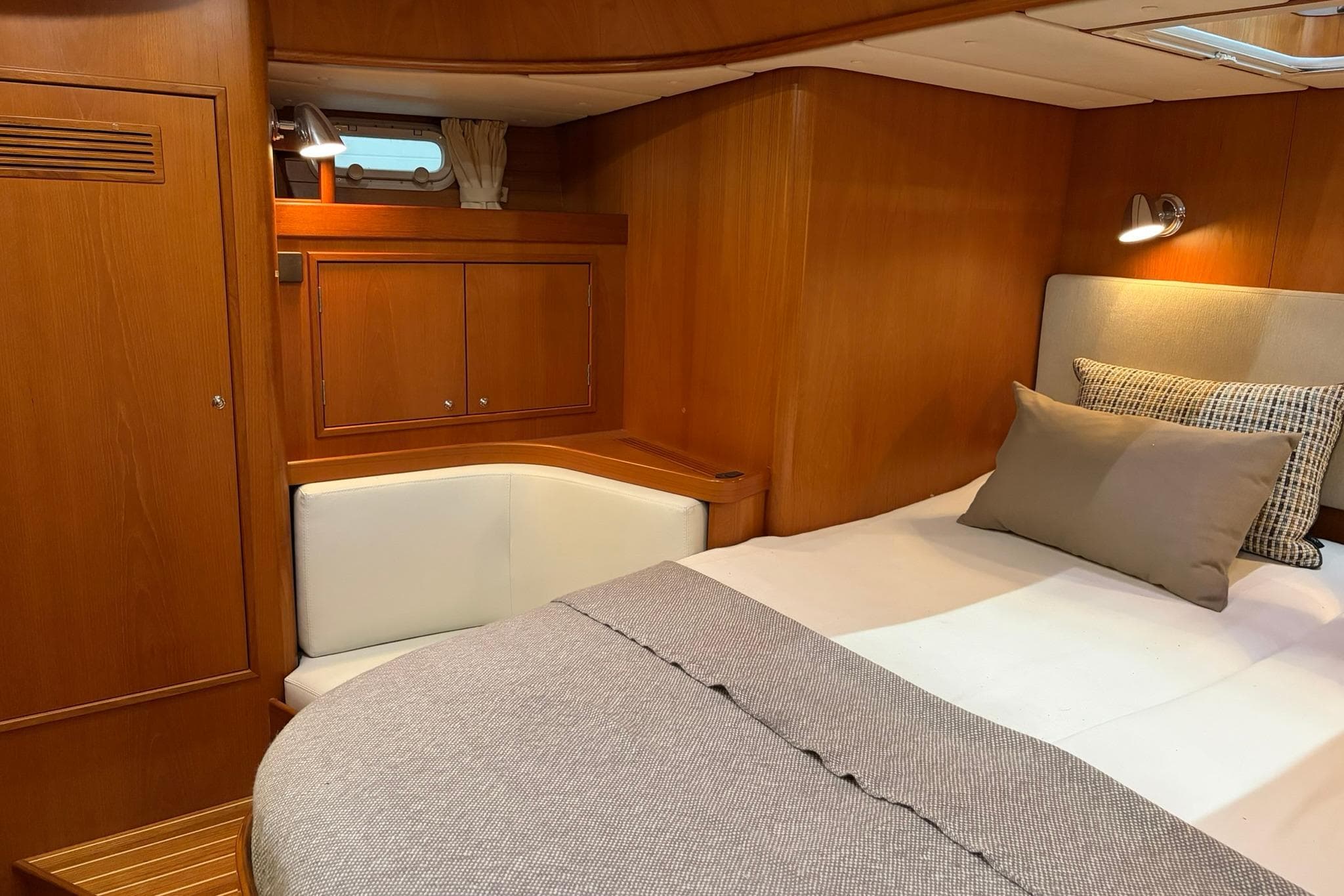 Luxurious cabin interior of 2006 Contest 50CS yacht with cozy bed and wooden finish.