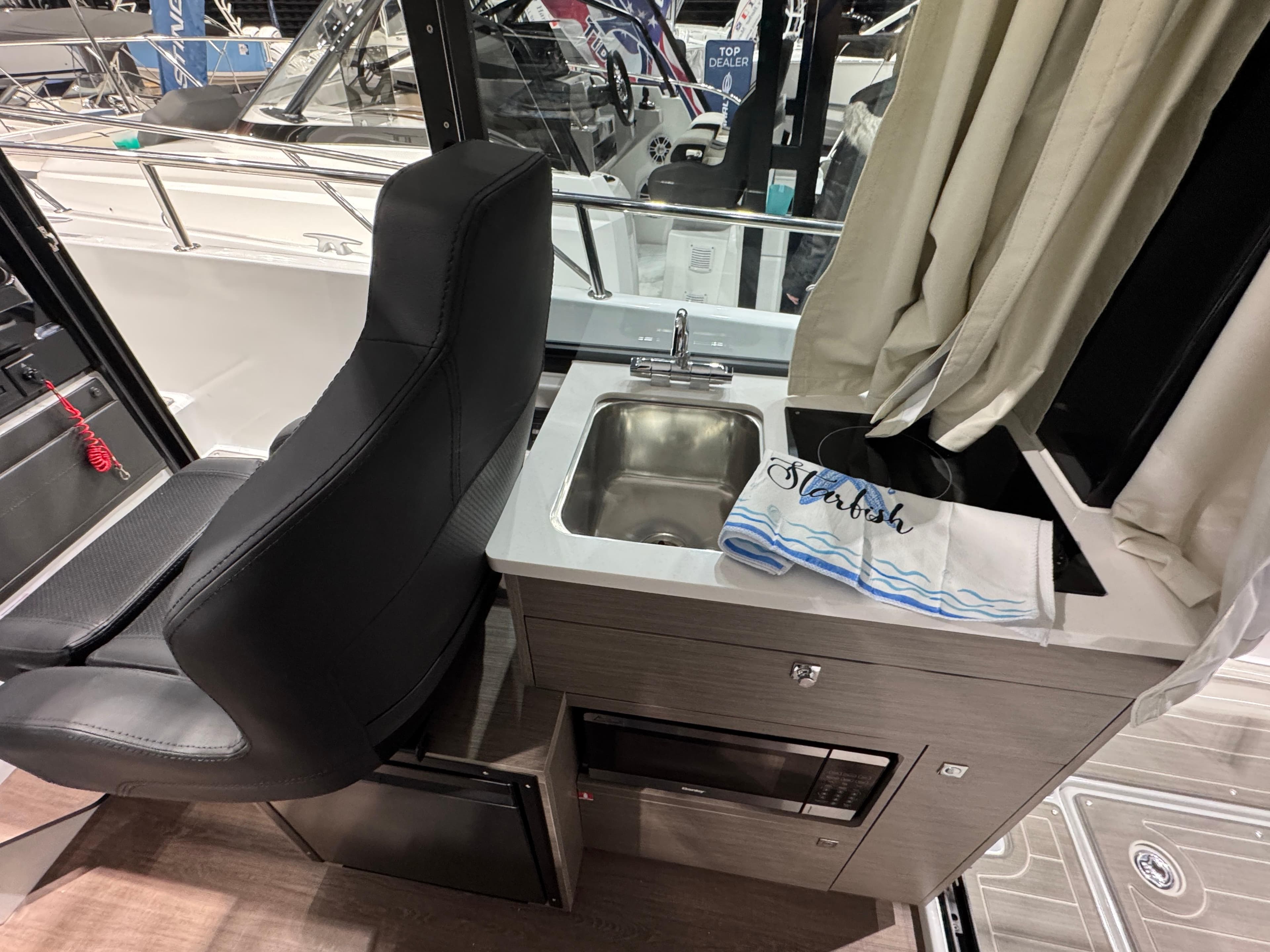 Interior of 2025 Jeanneau NC 895 Sport Series 2 with sink and seating.